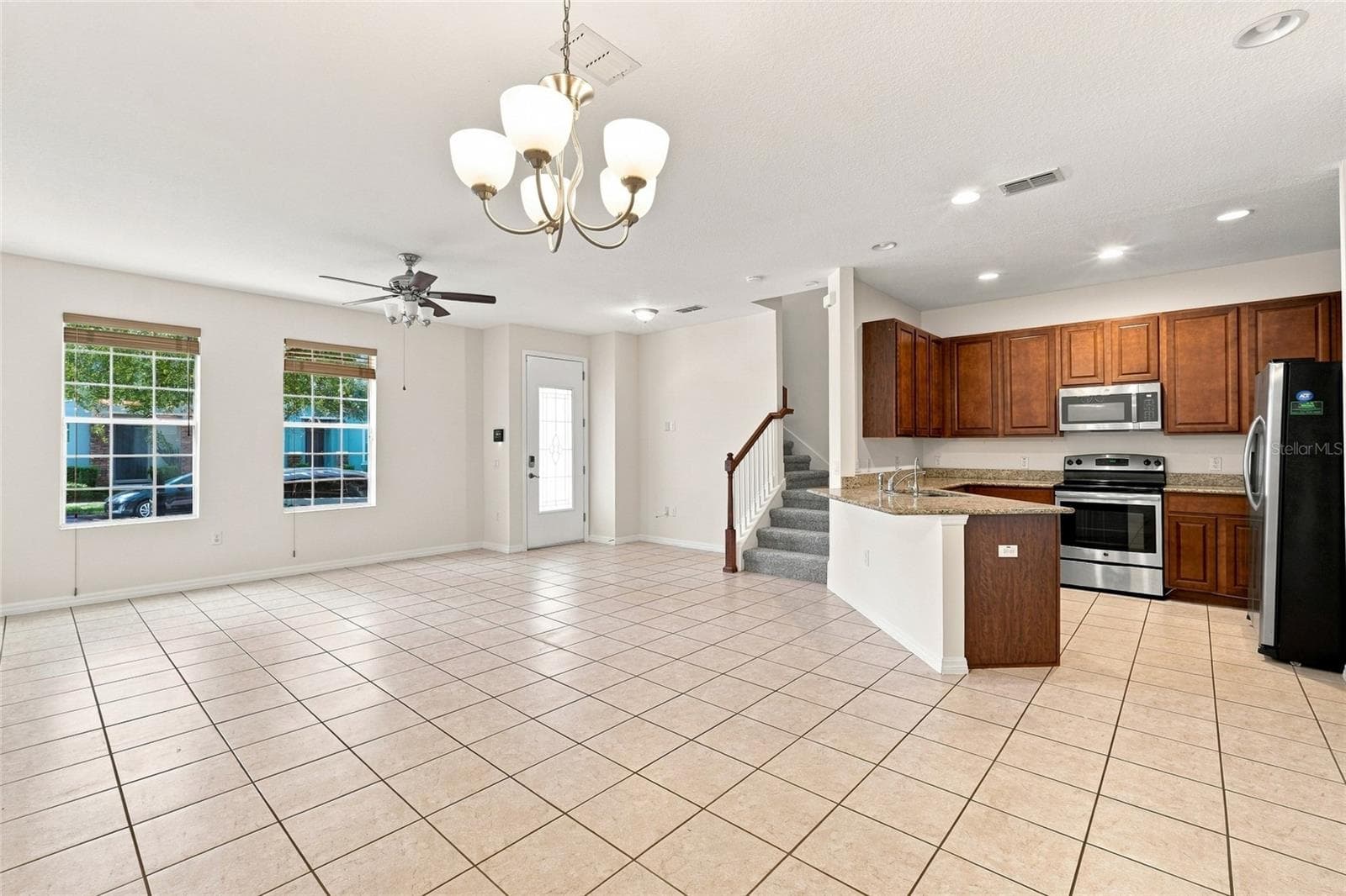 Spacious open-concept living and dining area - 13613 ERIDANUS DR, ORLANDO