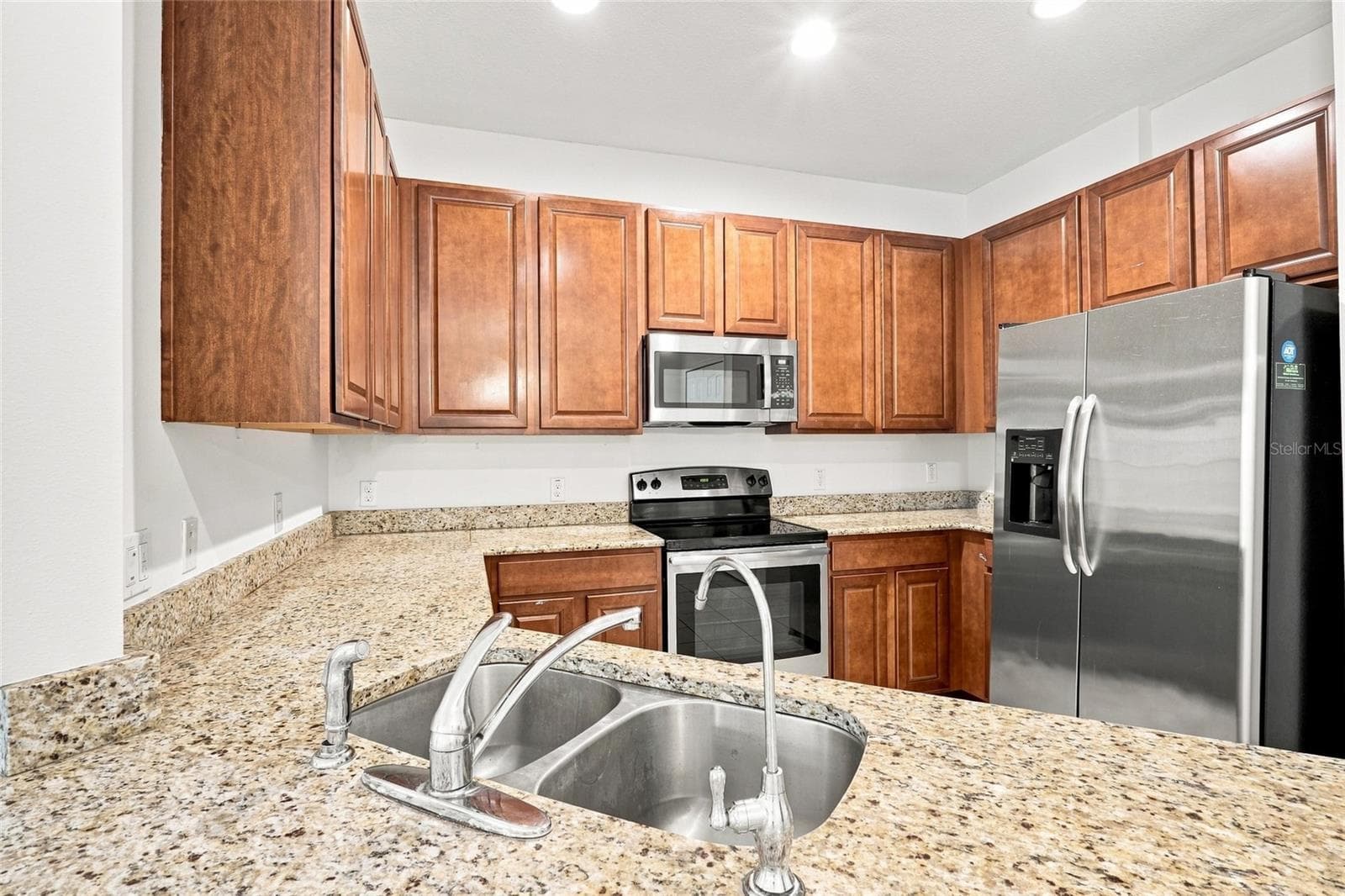 Kitchen with granite countertops and stainless-steel appliances - 13613 ERIDANUS DR, ORLANDO