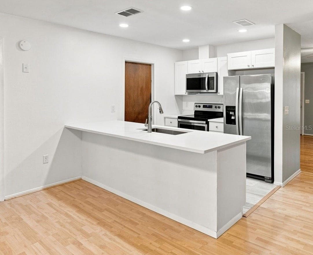 Kitchen with Quartz countertops, ss appliances - 4331 SWALLOWTAIL DR, NEW PORT RICHEY