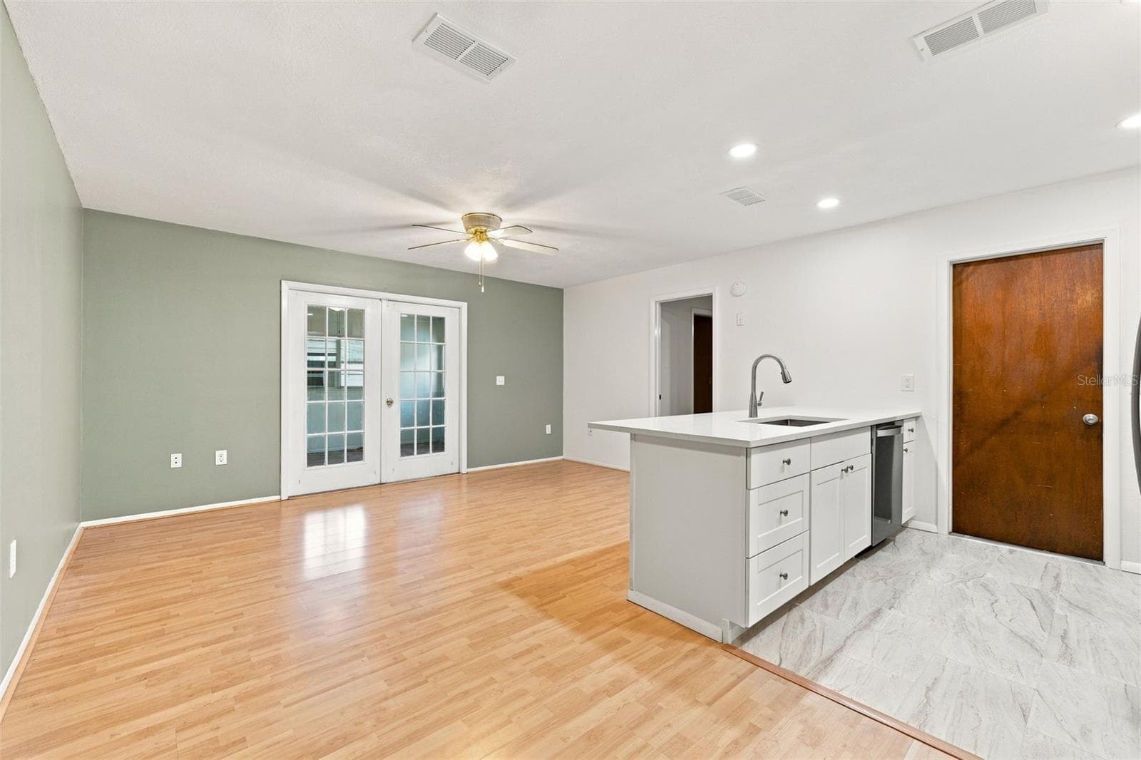 Second living room with french doors to bonus room - 4331 SWALLOWTAIL DR, NEW PORT RICHEY