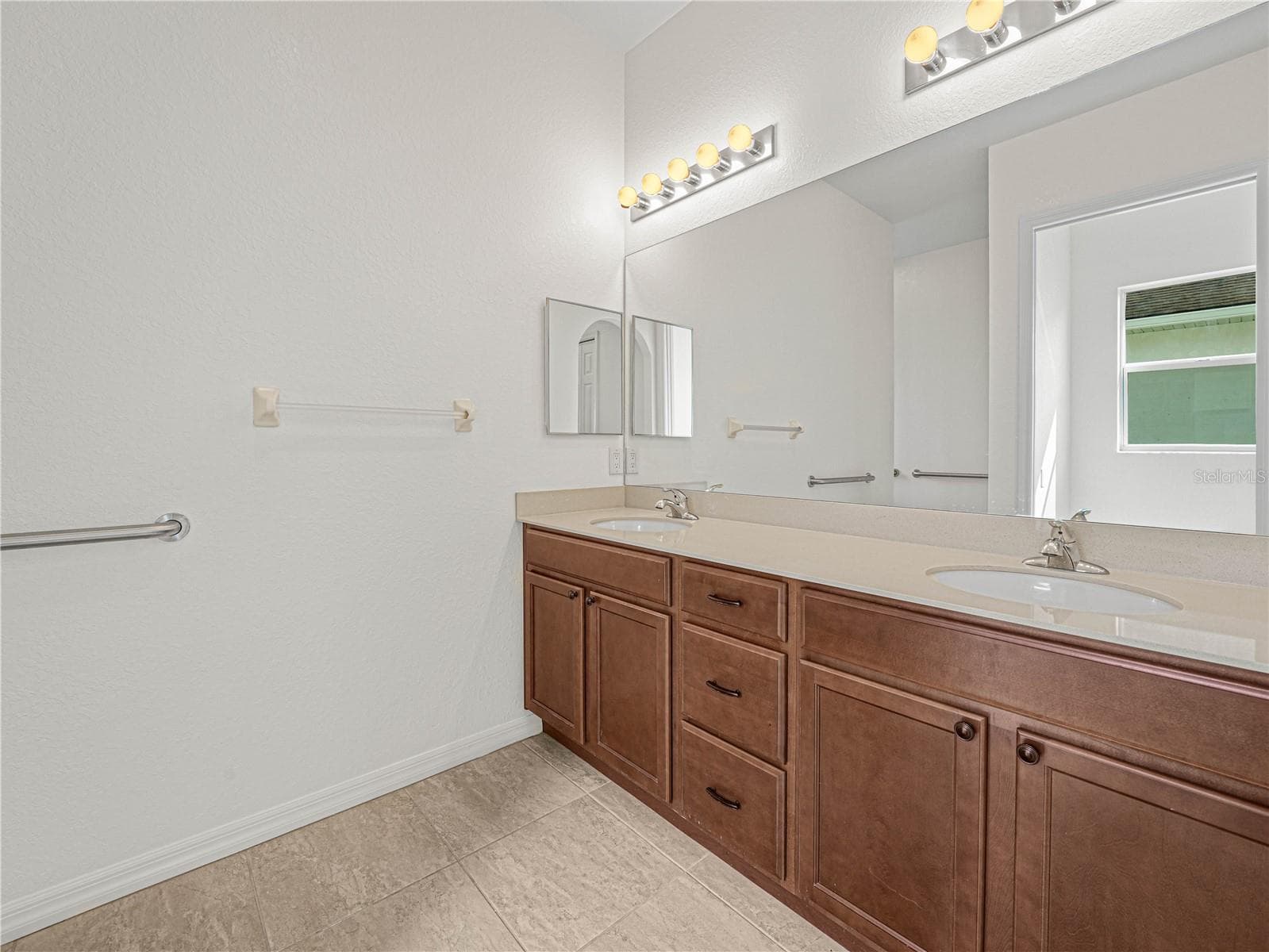 Double Sink Vanity in Primary Bath with Tile Flooring - 6136 PEBBLE BEACH BLVD, WINTER HAVEN