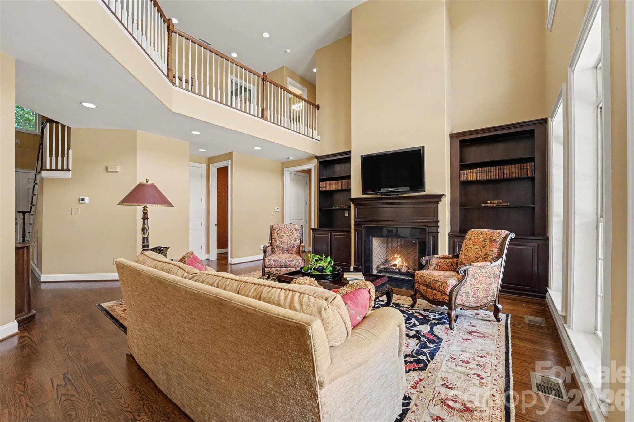 Two story great room with fireplace and built in bookshelves and storage on each side. - 120 Palos Verde Drive, Mooresville