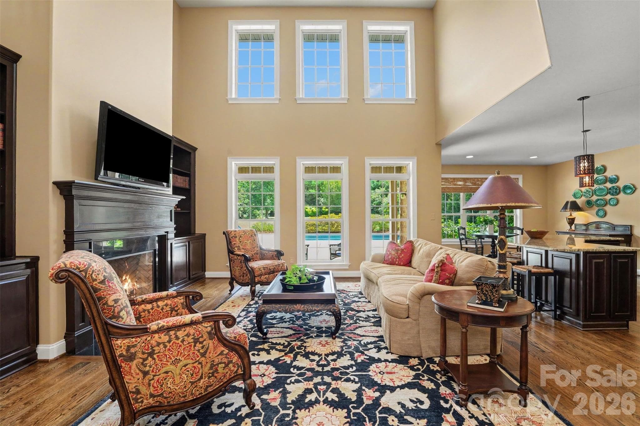 Great room overlooks the pool in and is open to the kitchen and breakfast nook.  Extra large windows provide natural sunlight. - 120 Palos Verde Drive, Mooresville