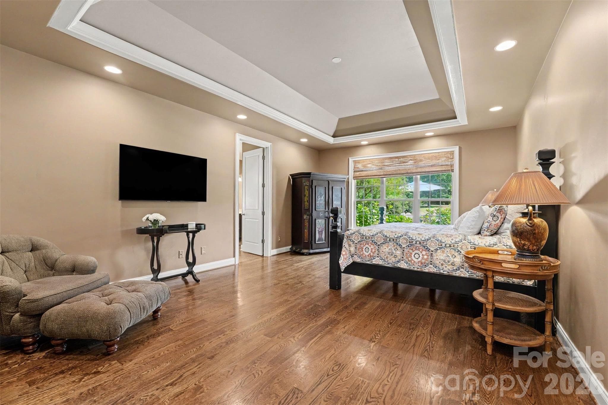 Main floor primary suite overlooking the back yard.  Walk in closet with a closet system and plenty of space for a separate sitting area. - 120 Palos Verde Drive, Mooresville