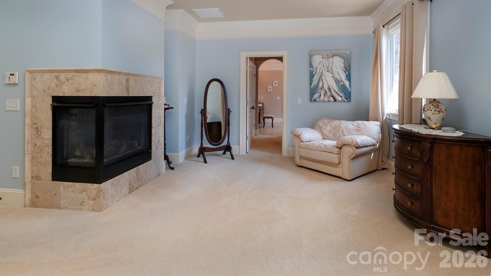 Gas fireplace in primary bedroom with sitting area... - 7786 Chapel Creek Drive, Denver
