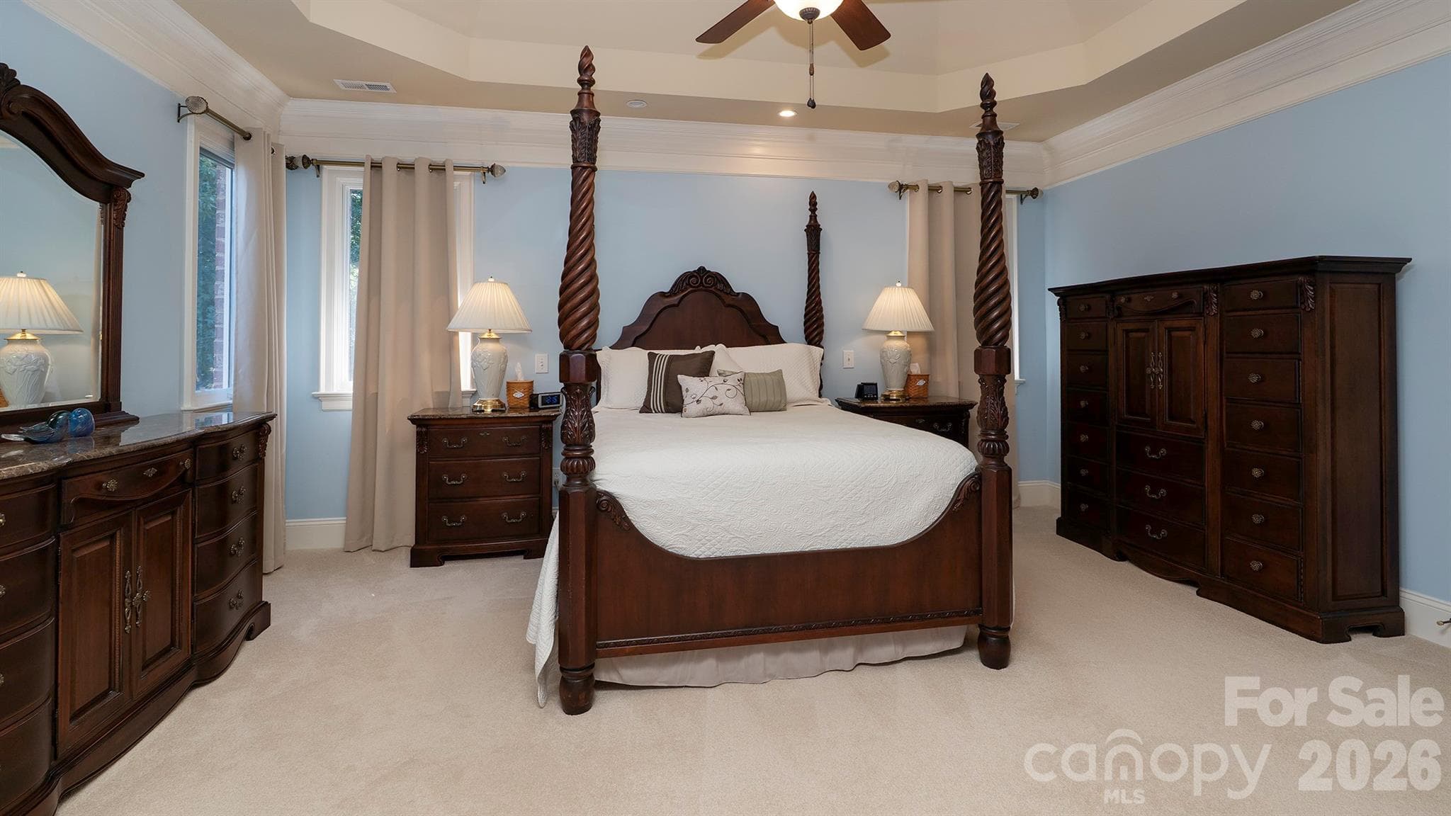Primary bedroom with tray ceiling... - 7786 Chapel Creek Drive, Denver