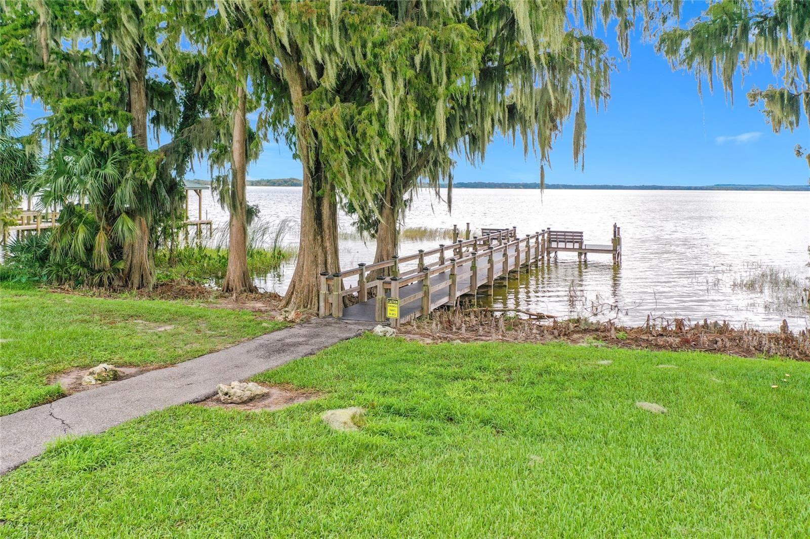 Waterfront amenities include a private fishing dock. - 5693 GULF STREAM STREET, TAVARES
