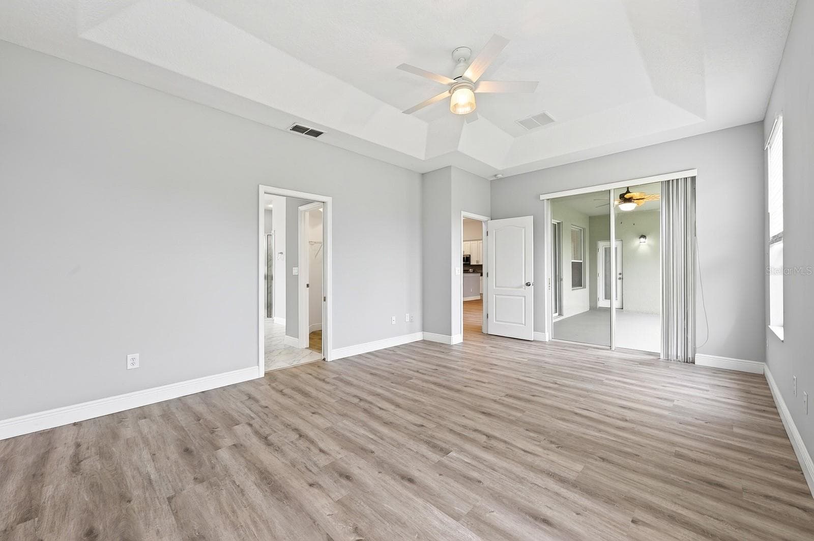 Light, bright, spacious primary suite has direct access to the lanai. - 4946 LAZY OAKS WAY, ST CLOUD