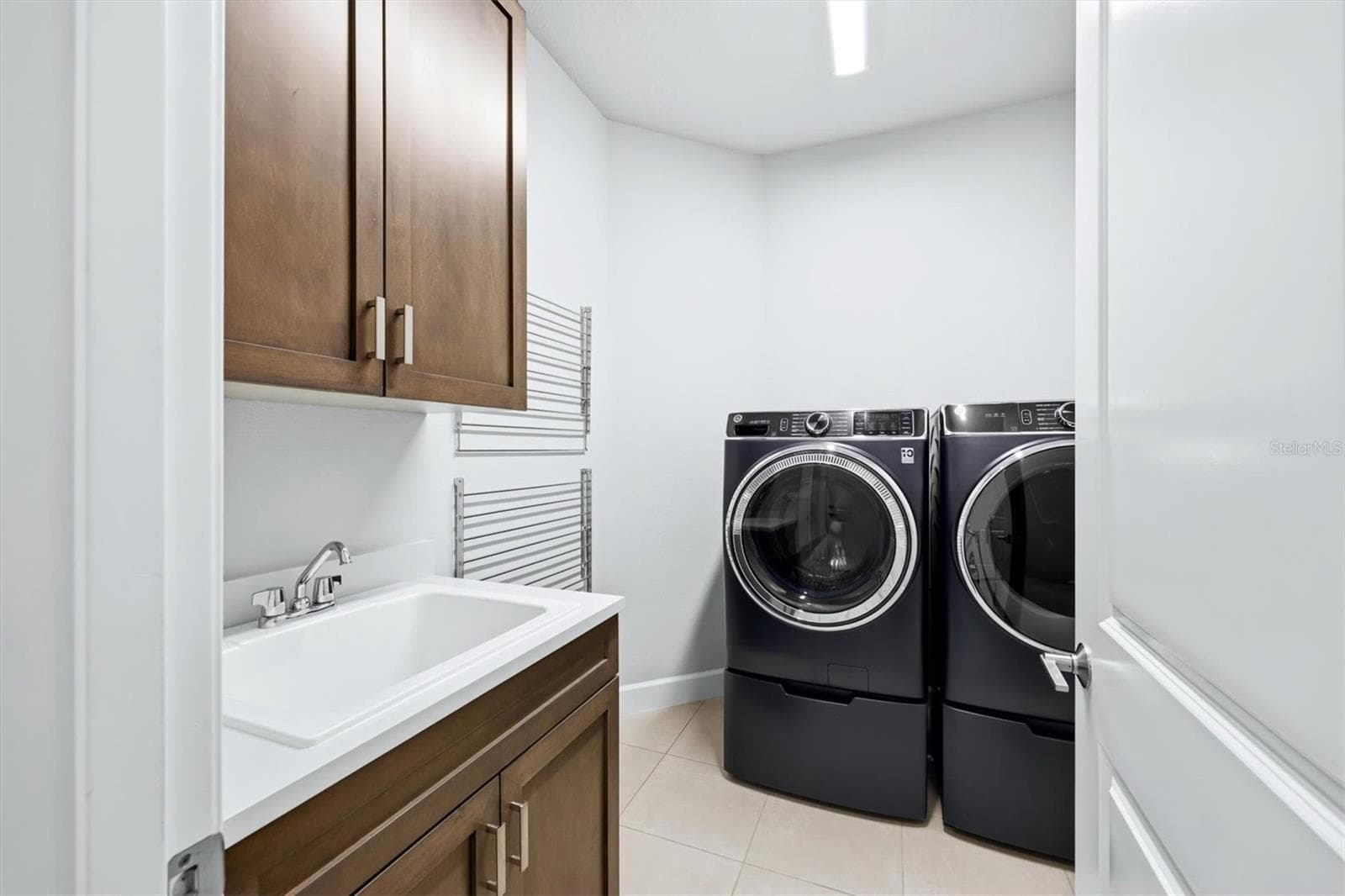 Laundry Room with Upper Cabinetry & Drying Racks - 7717 SANDHILL LAKE DR, SARASOTA