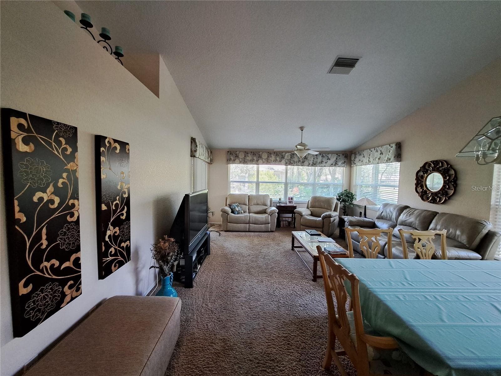 Large living room with all hurricane protected new windows and sliding door to screened porch - 5316 LOCHMEAD TER, ZEPHYRHILLS