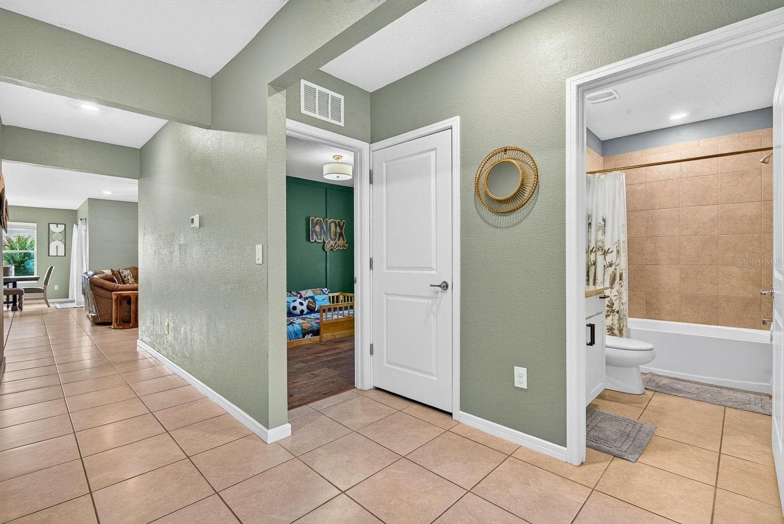 Large hallway showing entrance to bedroom and guest bath - 9348 ROYAL RIVER CIR, PARRISH
