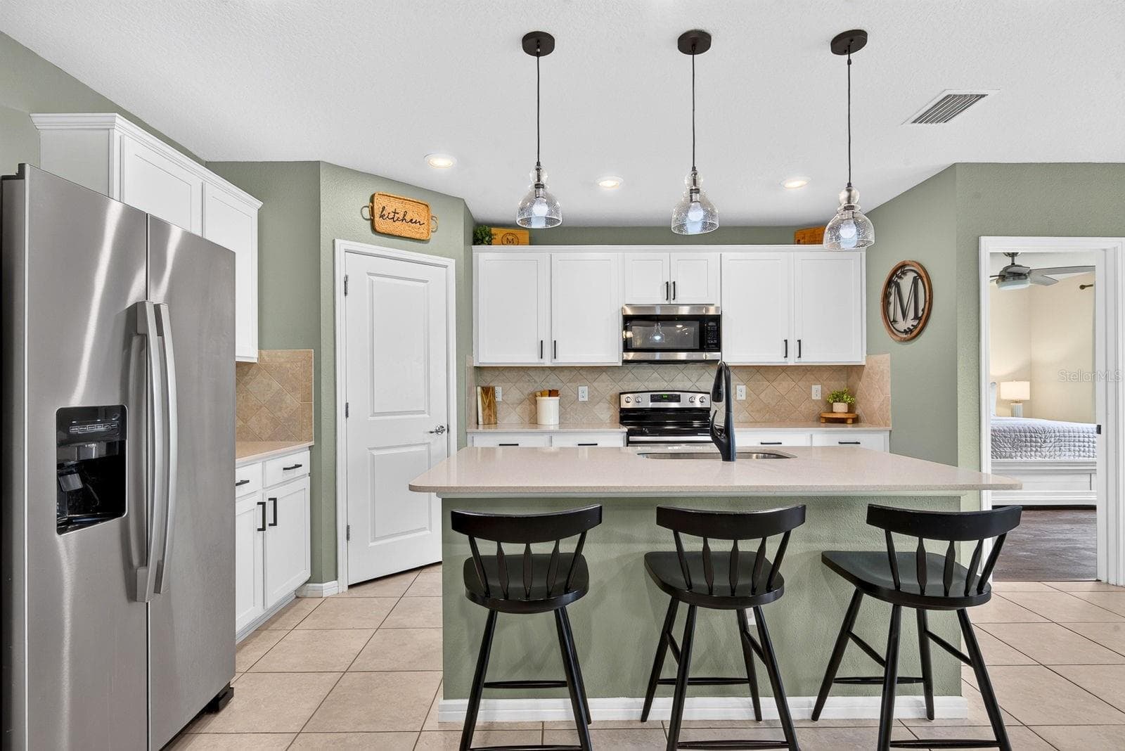 Facing into kitchen showing Master bedroom in the back of home - 9348 ROYAL RIVER CIR, PARRISH