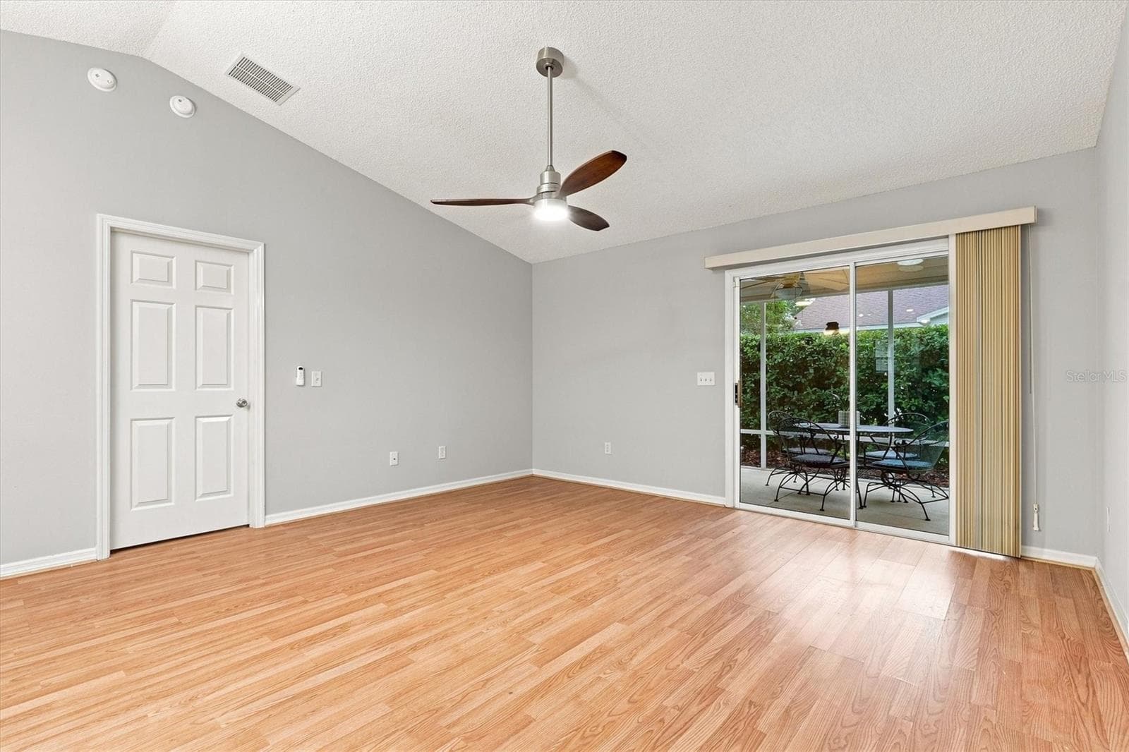Living room: "Open living room with laminate flooring in The Villages Summerhill home" - 3565 IDLEWOOD LOOP, THE VILLAGES