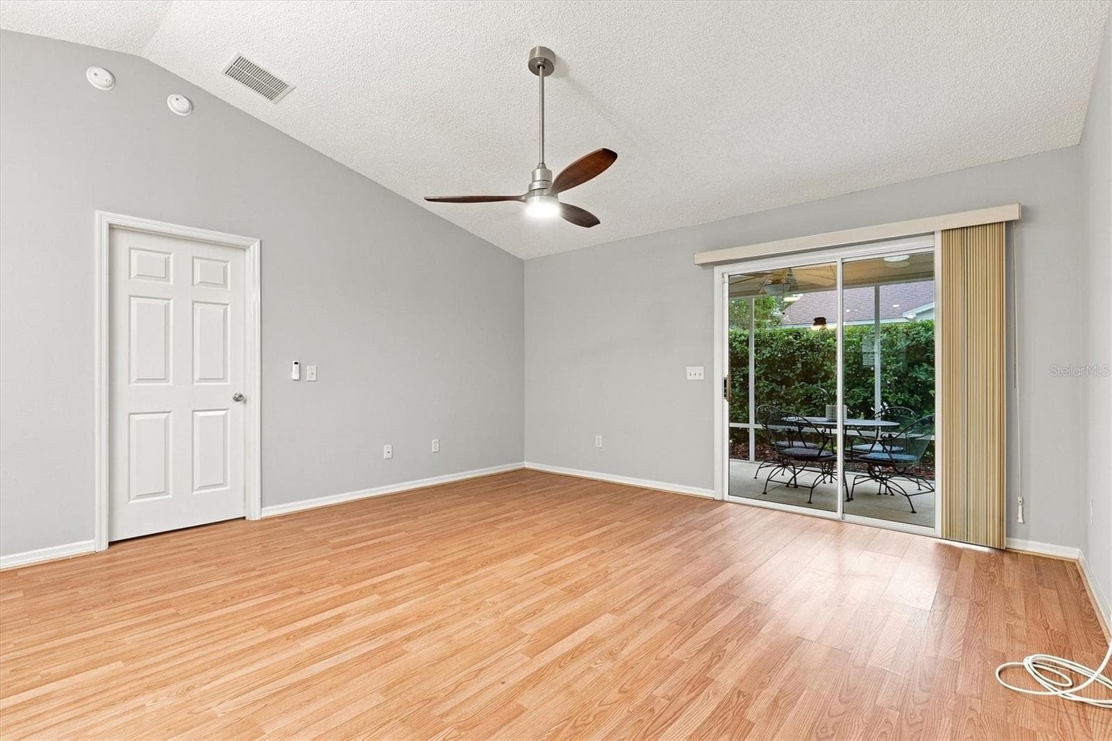 Living room: "Open living room with laminate flooring in The Villages Summerhill home" - 3565 IDLEWOOD LOOP, THE VILLAGES