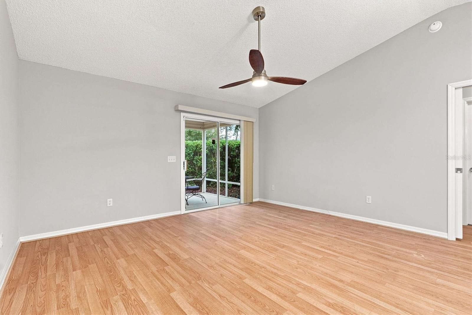 Living room: "Open living room with laminate flooring in The Villages Summerhill home" - 3565 IDLEWOOD LOOP, THE VILLAGES