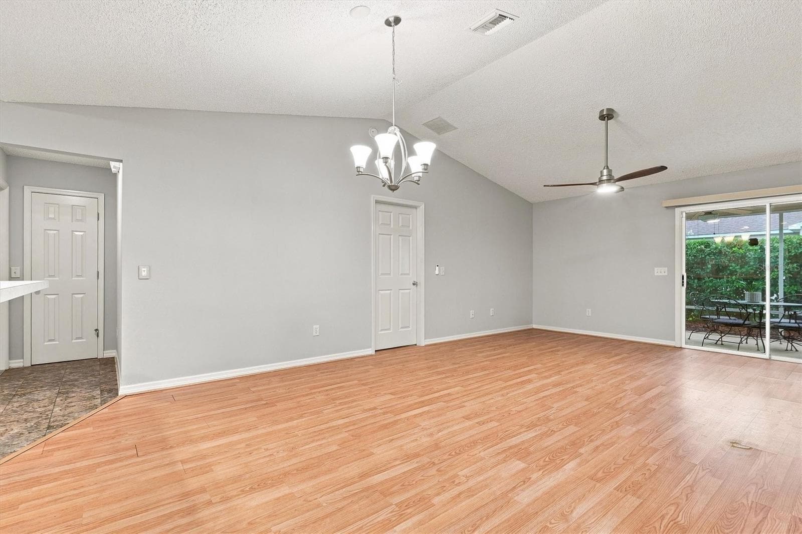 Living room: "Open living room with laminate flooring in The Villages Summerhill home" - 3565 IDLEWOOD LOOP, THE VILLAGES