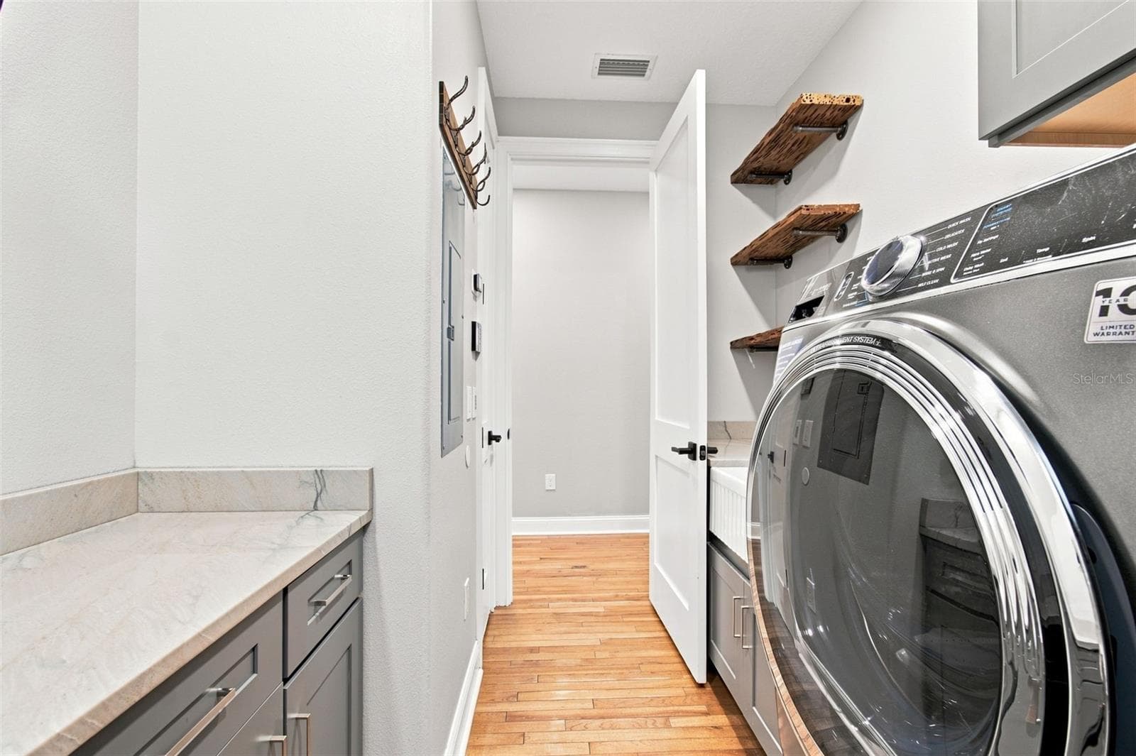LAUNDRY ROOM SINK AND PECKY CYPRESS SHELVES - 14122 CHESTERFIELD TRL, HUDSON
