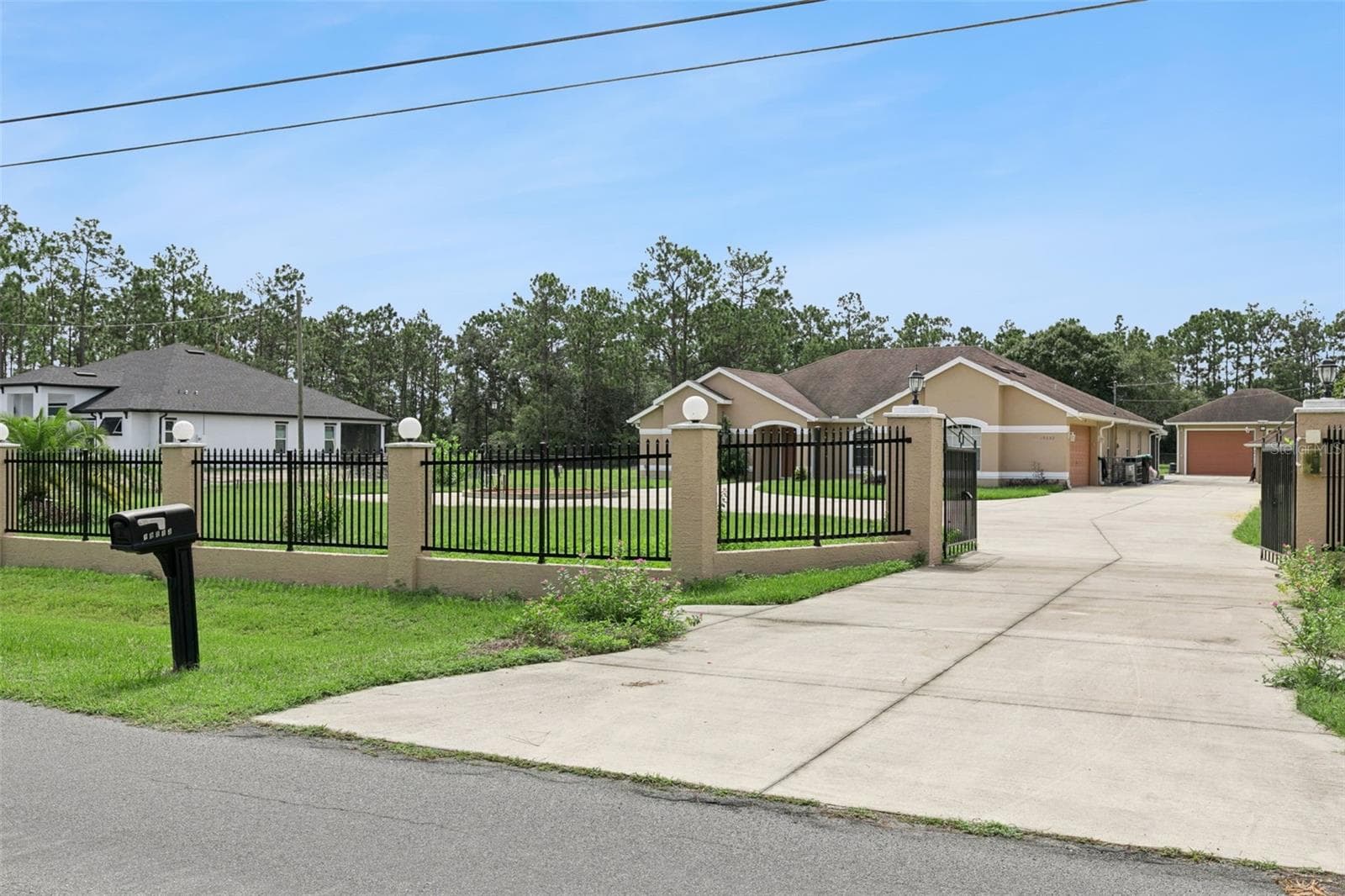 Through these gates you are entering into a home that sits on 1.74 acres - 19532 SHELDON ST, ORLANDO
