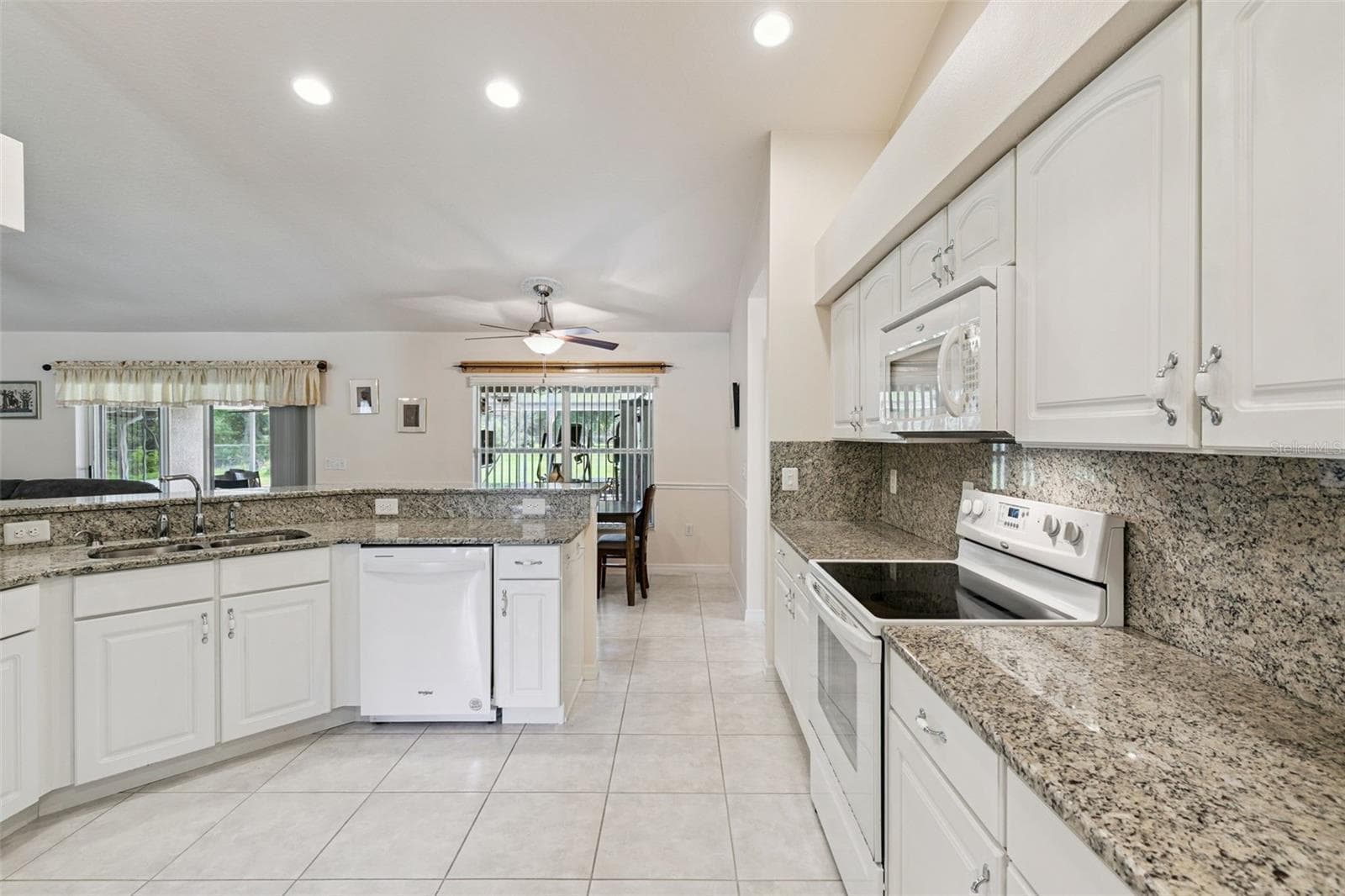 Kitchen featuring wood cabinets and granite countertops - 19532 SHELDON ST, ORLANDO