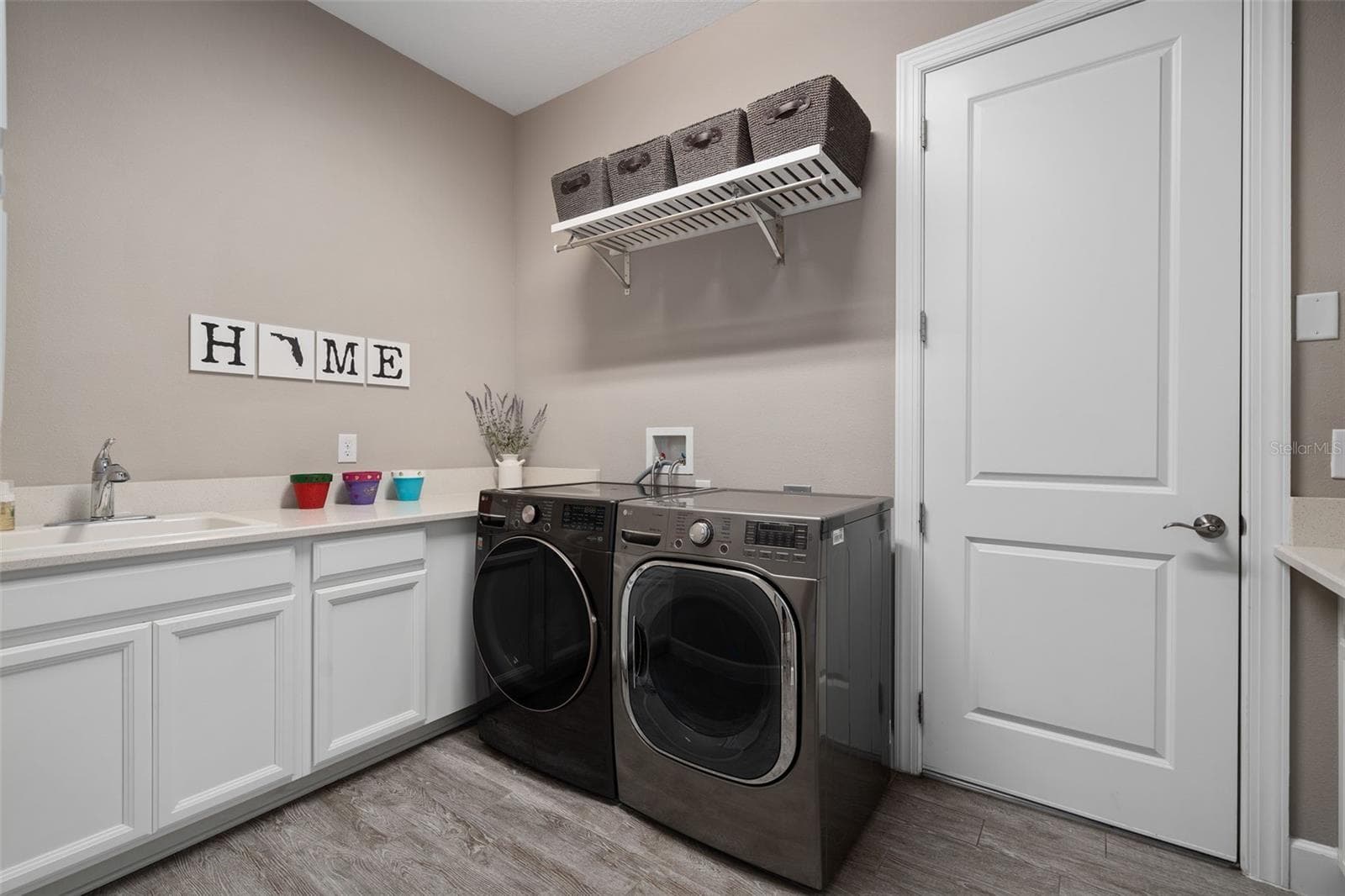 The laundry room has a sink and a drop area for your convenience. - 1279 ZEEK RIDGE ST, CLERMONT