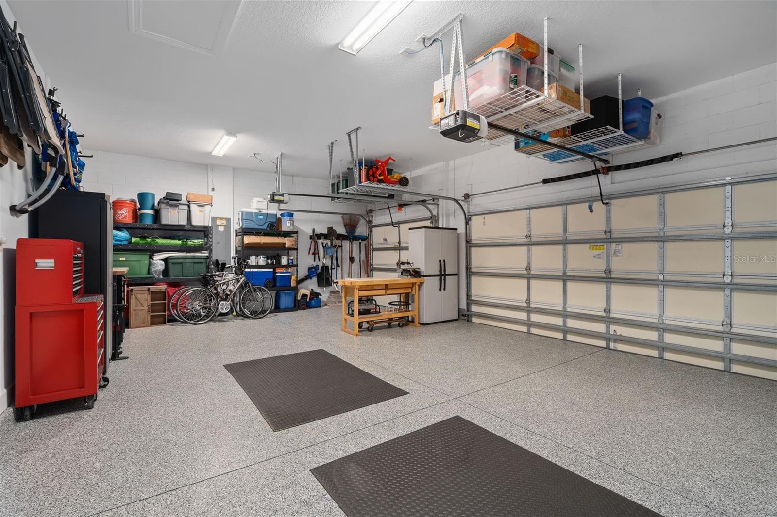 This full 3 car garage with a "Shark Coating" floor, Insulated garage doors and ceiling storage. - 1279 ZEEK RIDGE ST, CLERMONT