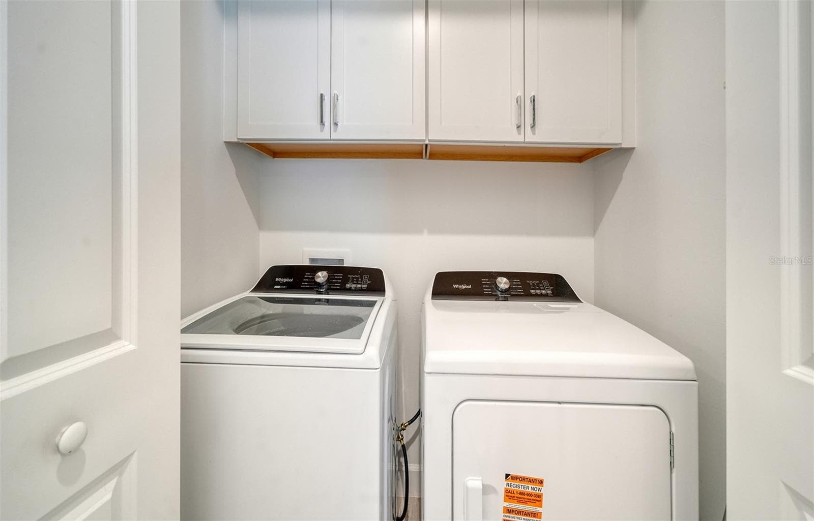 Laundry inside the villa with cabinets for storage - 14229 EAGLE BRANCH DR, NOKOMIS