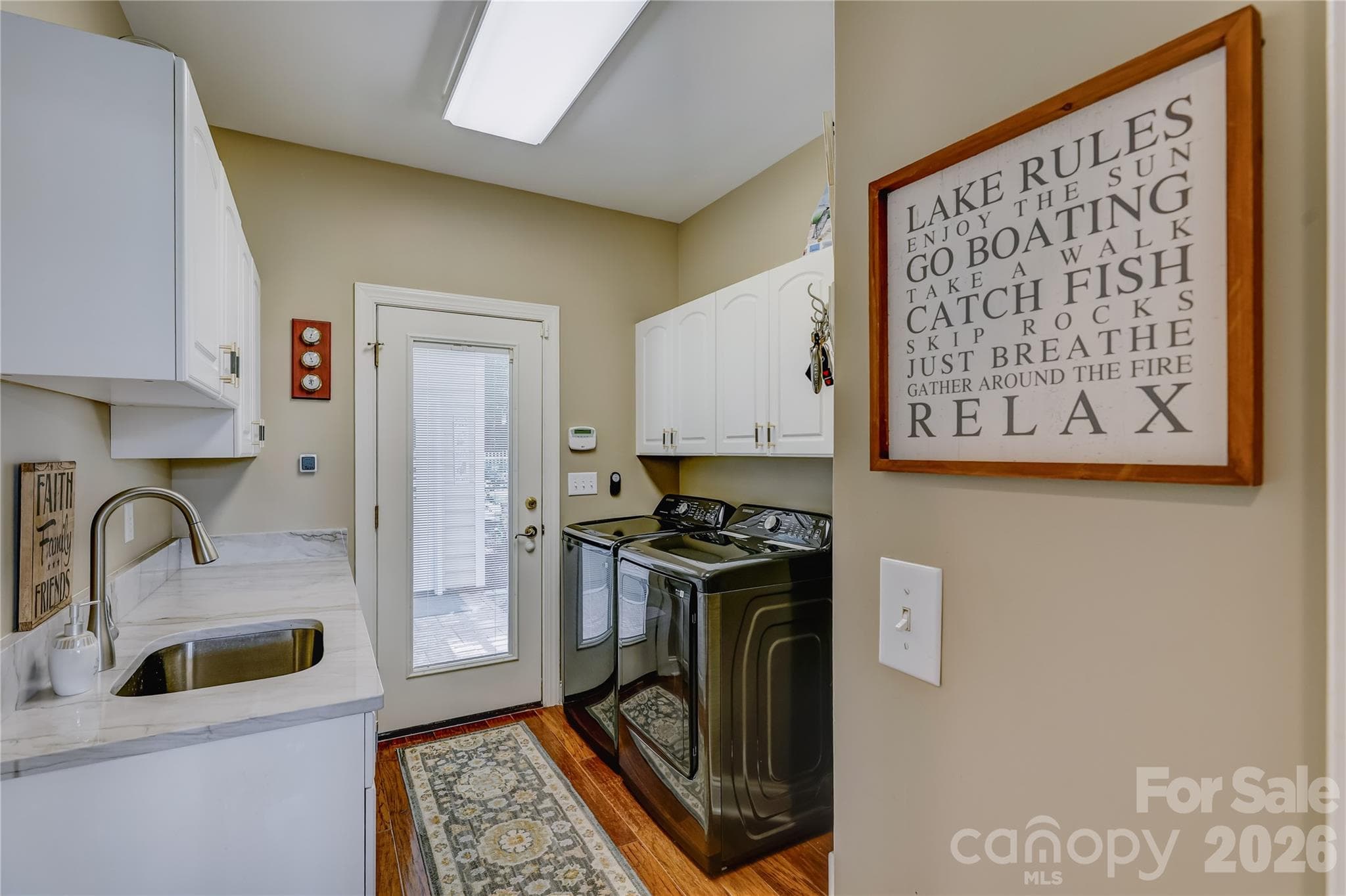 Large laundry room on the main level with direct access to the backyard. - 946 Lake Club Drive, Rock Hill
