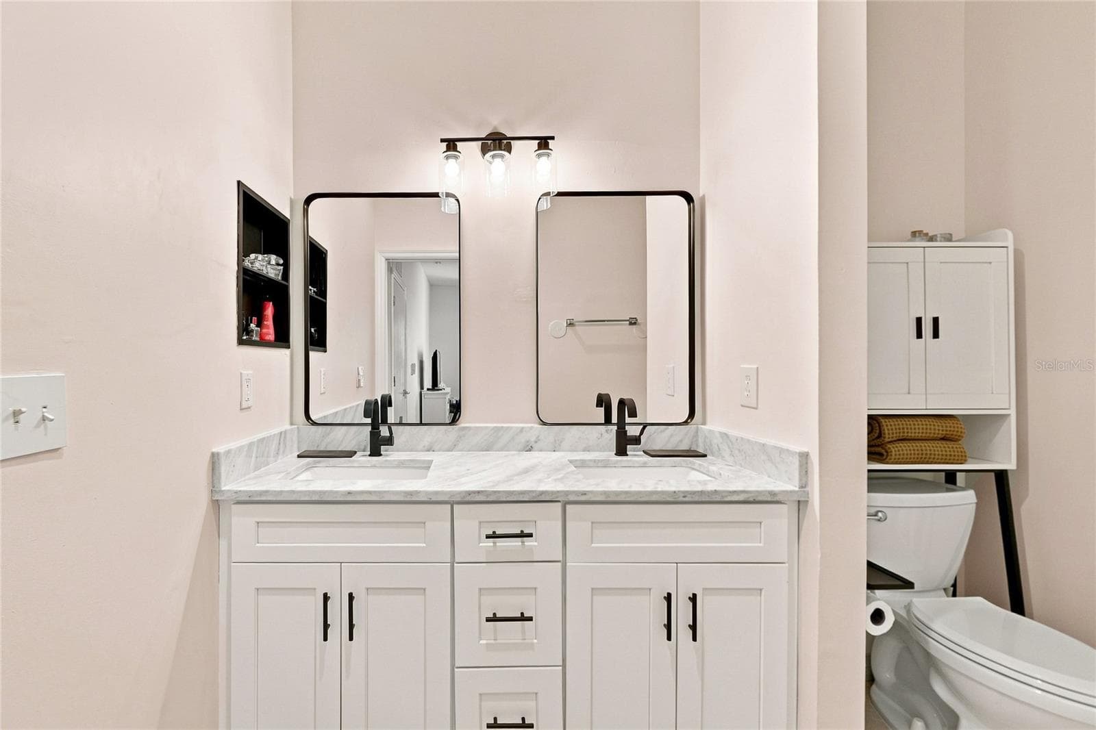 Updated primary bathroom with dual sinks and mirrors - 8423 BERNWOOD COVE LOOP #410, FORT MYERS