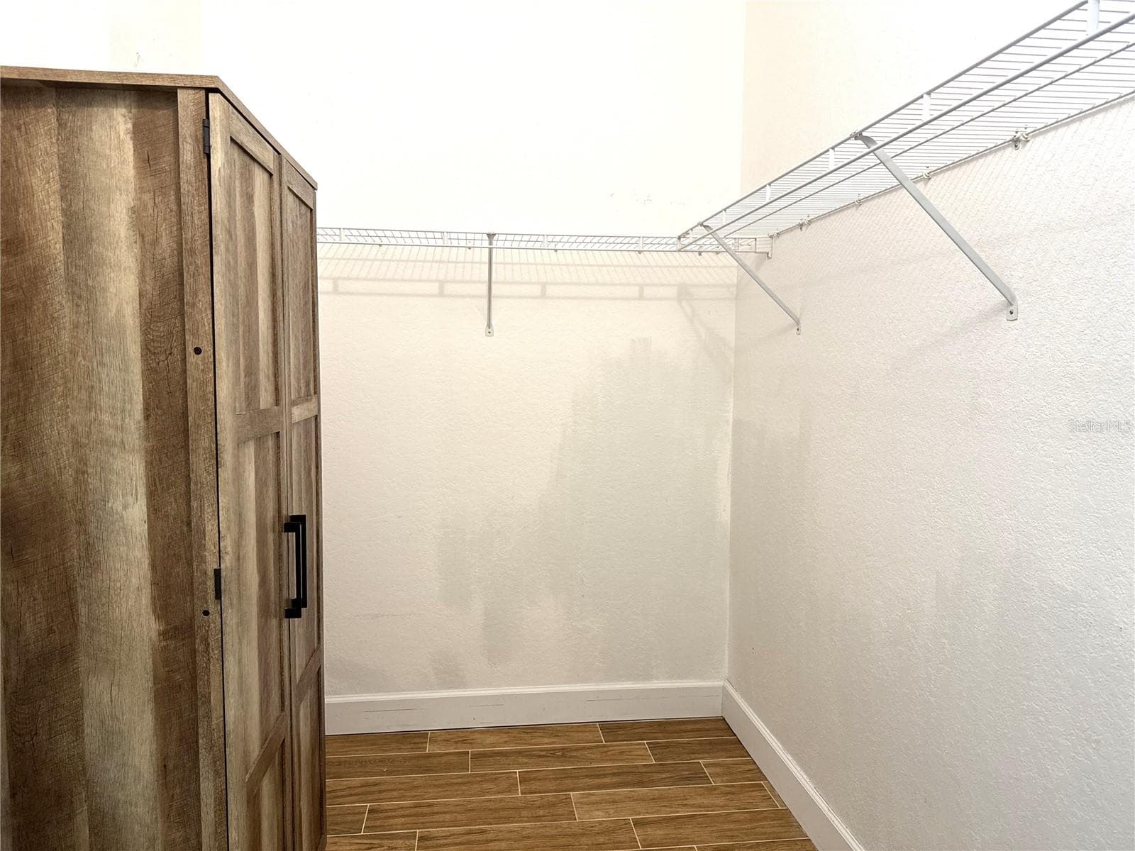 Primary bedroom walk-in closet - 8423 BERNWOOD COVE LOOP #410, FORT MYERS