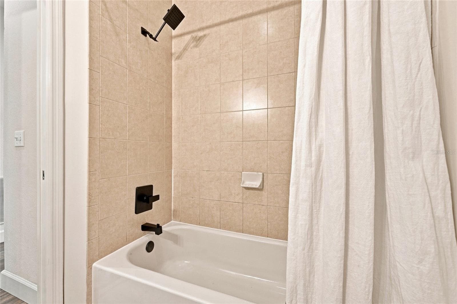 Guest bathroom with tub/shower combination - 8423 BERNWOOD COVE LOOP #410, FORT MYERS