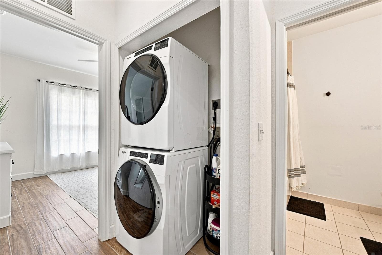 Laundry in private guest hallway with a pocket door for privacy - 8423 BERNWOOD COVE LOOP #410, FORT MYERS