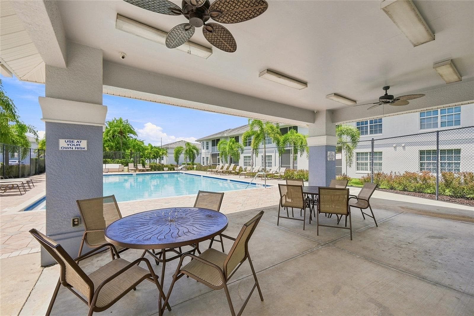 Gathering area at the community swimming pool - 8423 BERNWOOD COVE LOOP #410, FORT MYERS