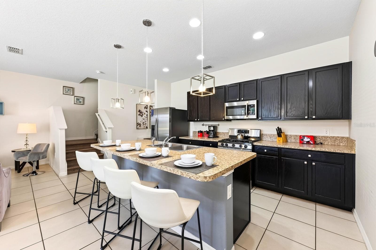 A generous center island offers extra prep space and room for counter-height seating. - 4722 TERRASONESTA DR, DAVENPORT