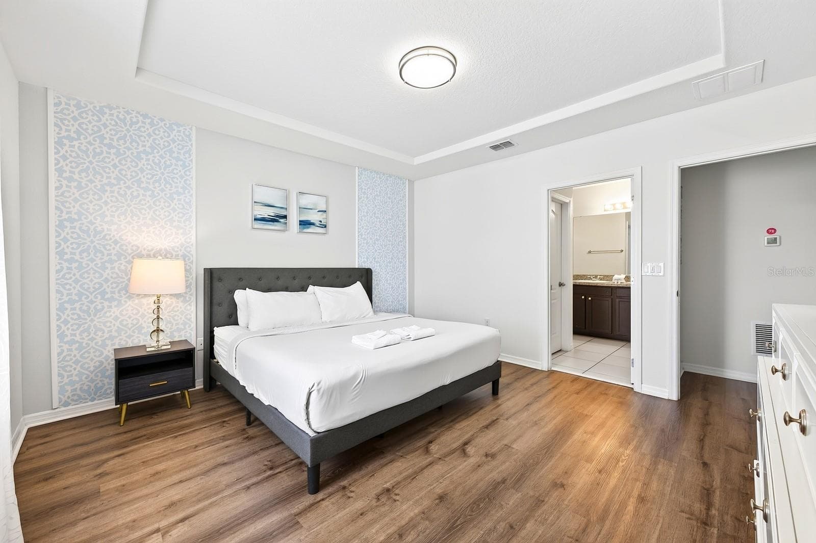 The spacious PRIMARY SUITE offers a relaxing retreat with a TRAY CEILING, WALK-IN CLOSET and private en-suite bath. - 4722 TERRASONESTA DR, DAVENPORT