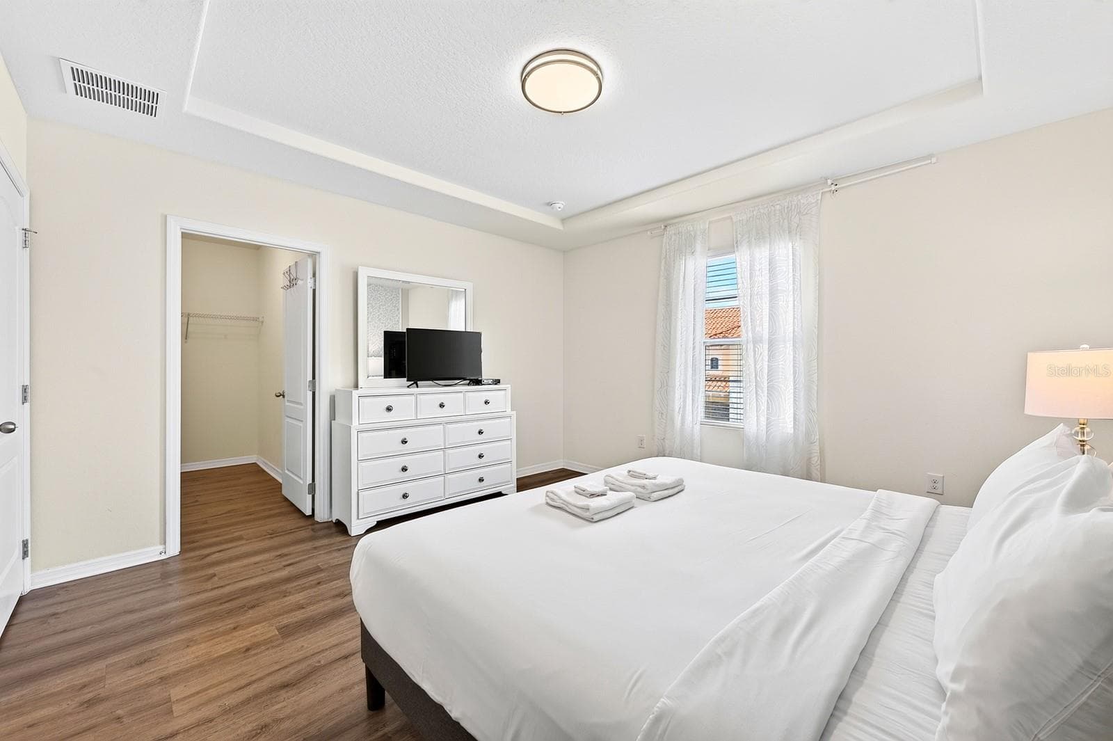 The spacious PRIMARY SUITE offers a relaxing retreat with a TRAY CEILING, WALK-IN CLOSET and private en-suite bath. - 4722 TERRASONESTA DR, DAVENPORT