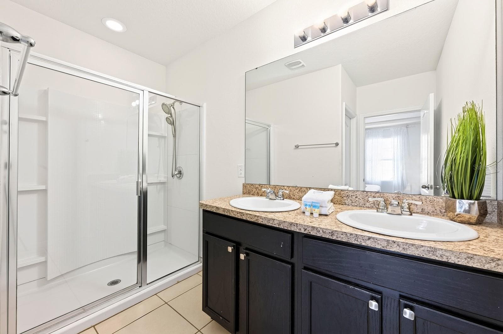 The private Primary en-suite bath features DUAL SINKS, a STEP-IN SHOWER and PRIVATE WATER CLOSET. - 4722 TERRASONESTA DR, DAVENPORT