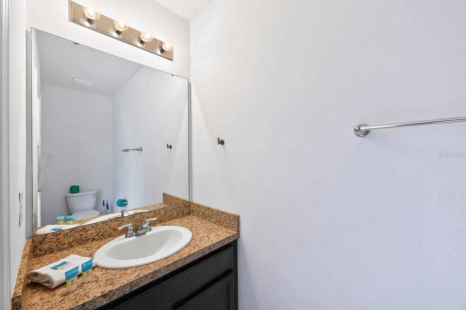 A convenient HALF BATH is located just off the pool area, perfect for guests. - 4722 TERRASONESTA DR, DAVENPORT