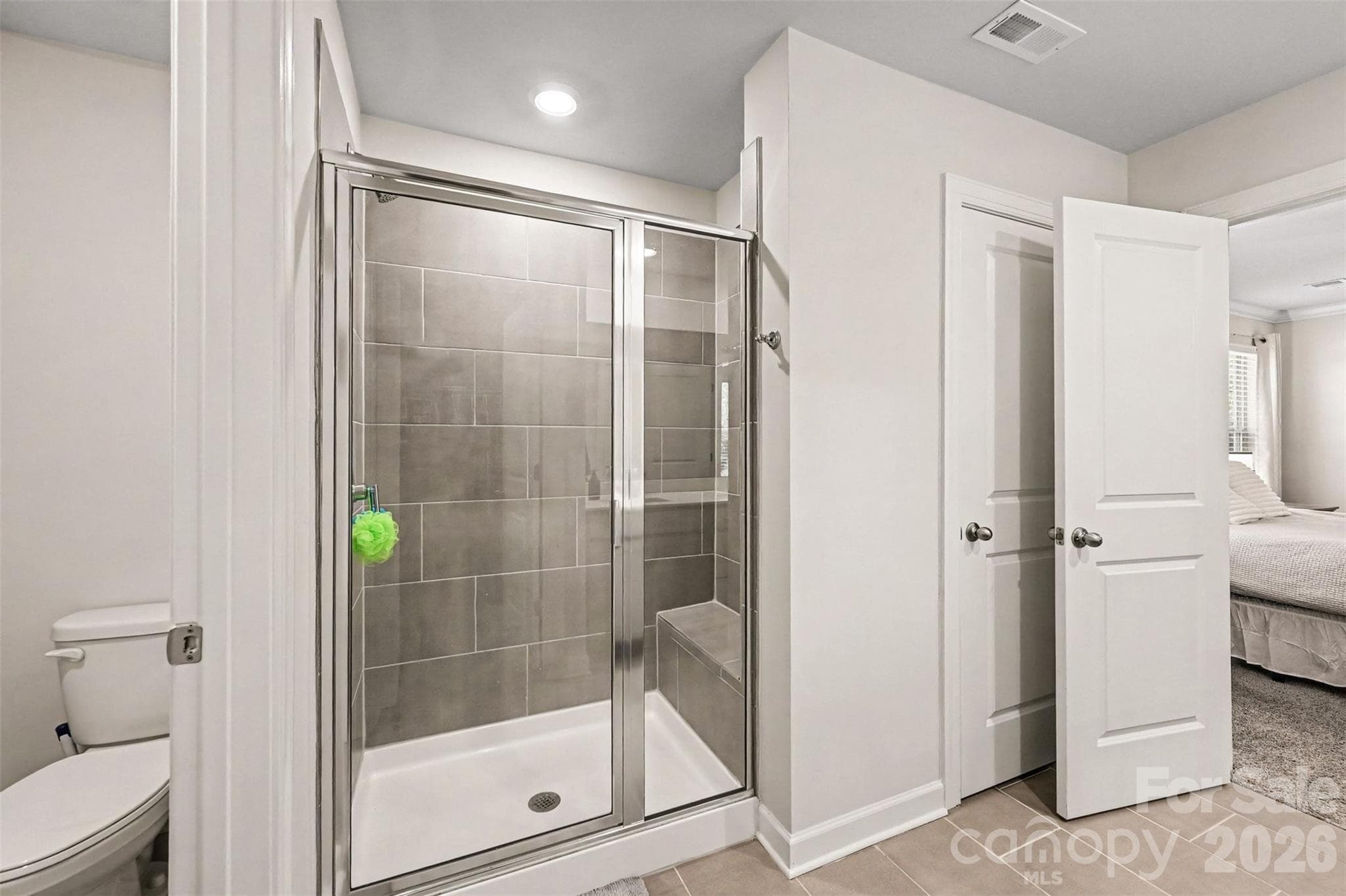 The ensuite bathroom has a water closet, roomy tiled shower,... - 408 Luna Lane, Shelby