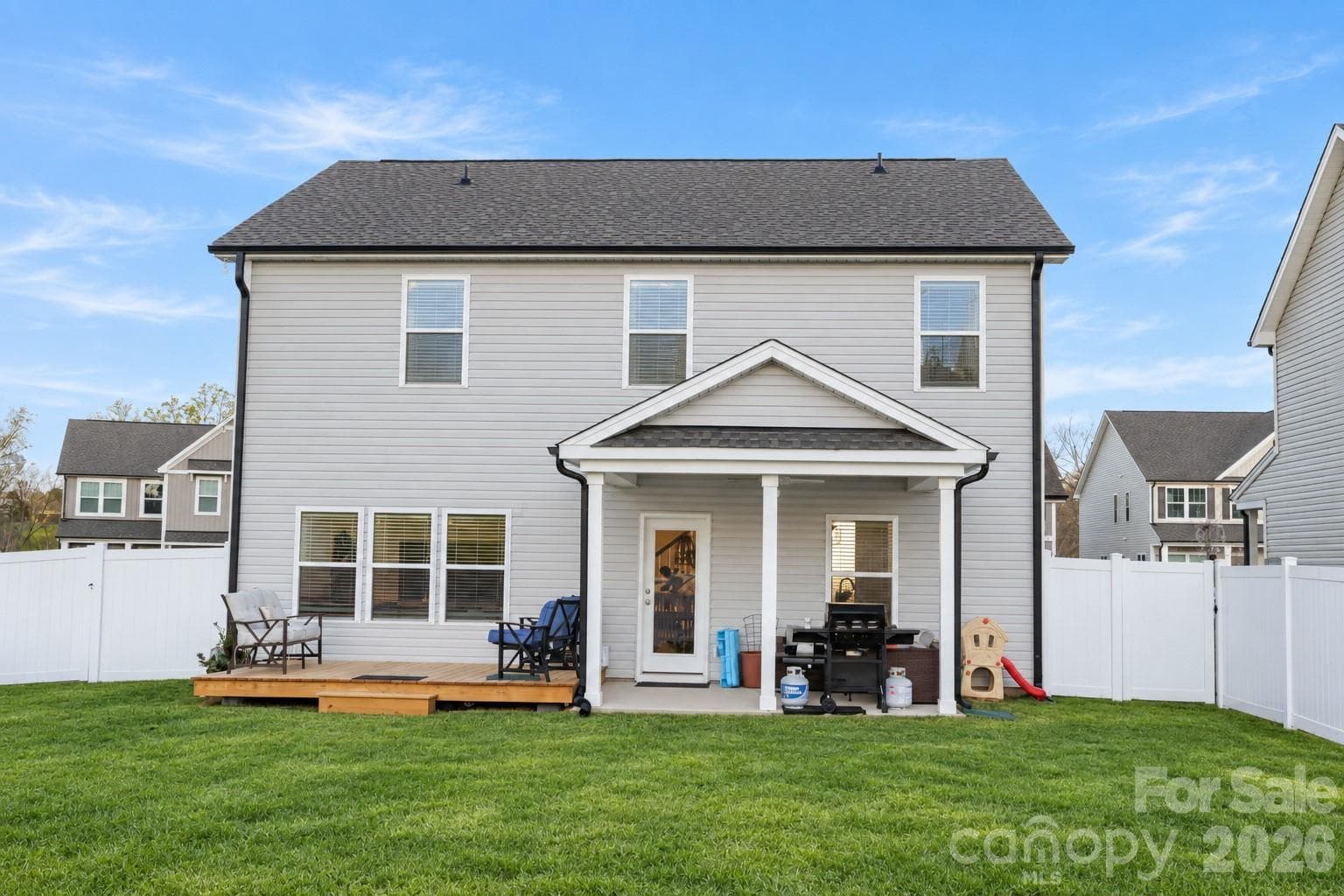 Relaxing covered patio with ceiling fan and attached deck - 106 Stonewater Drive, Stanfield