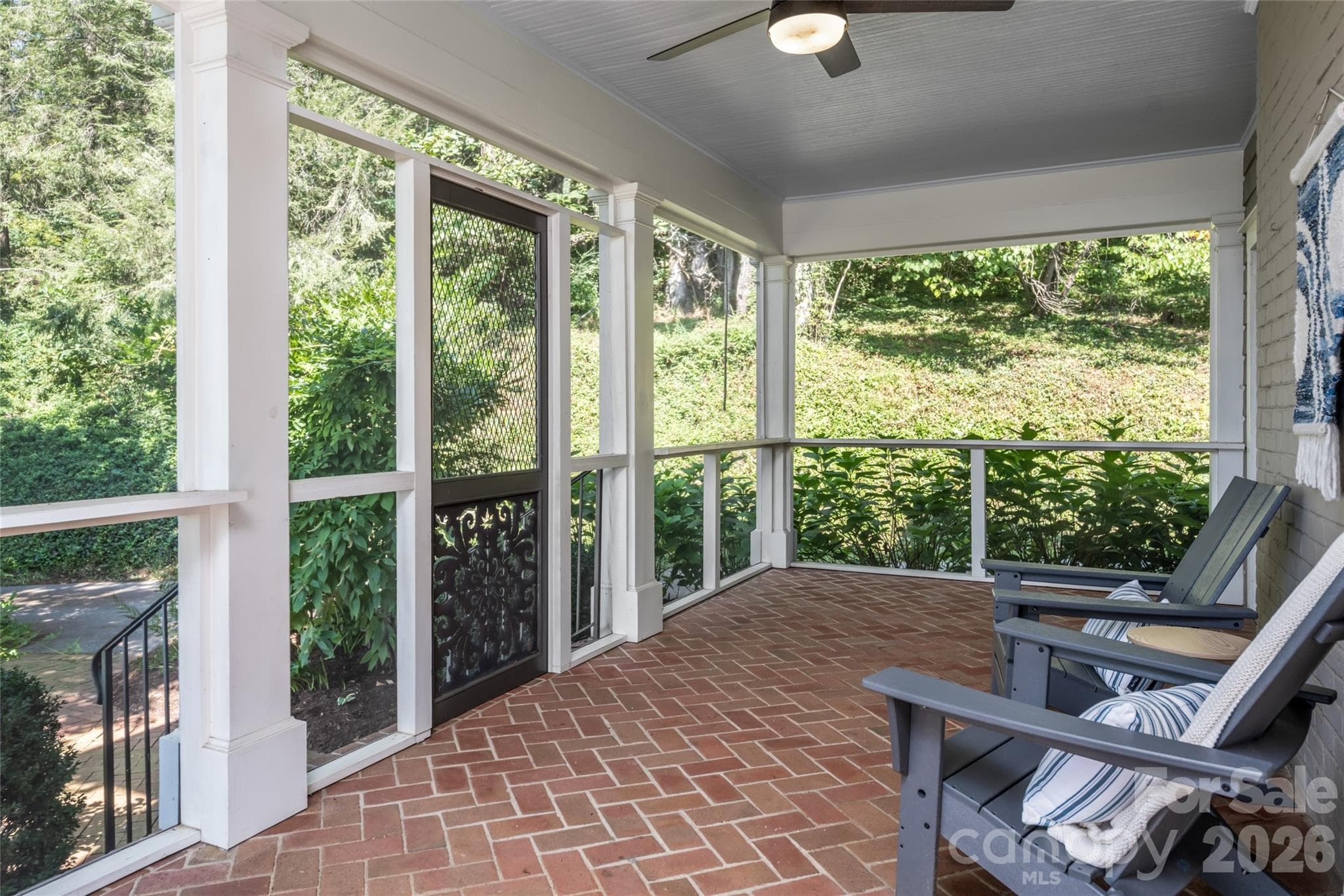 The screened in porch has room for an outdoor dining table and conversational seating area - 35 Elias Place, Asheville