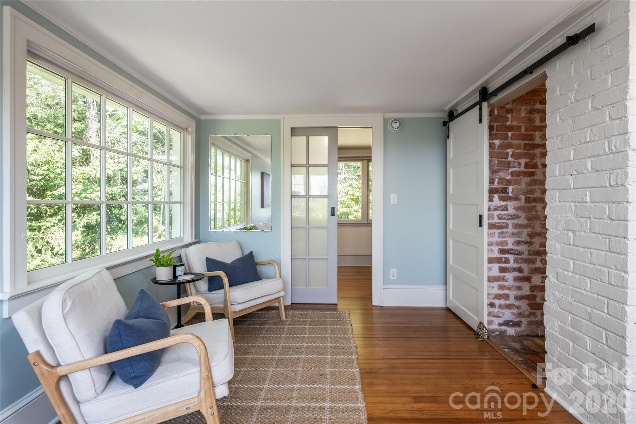 The sitting room off the primary bedroom features access into one of the two primary closets as well as the Primary Bathroom - 35 Elias Place, Asheville