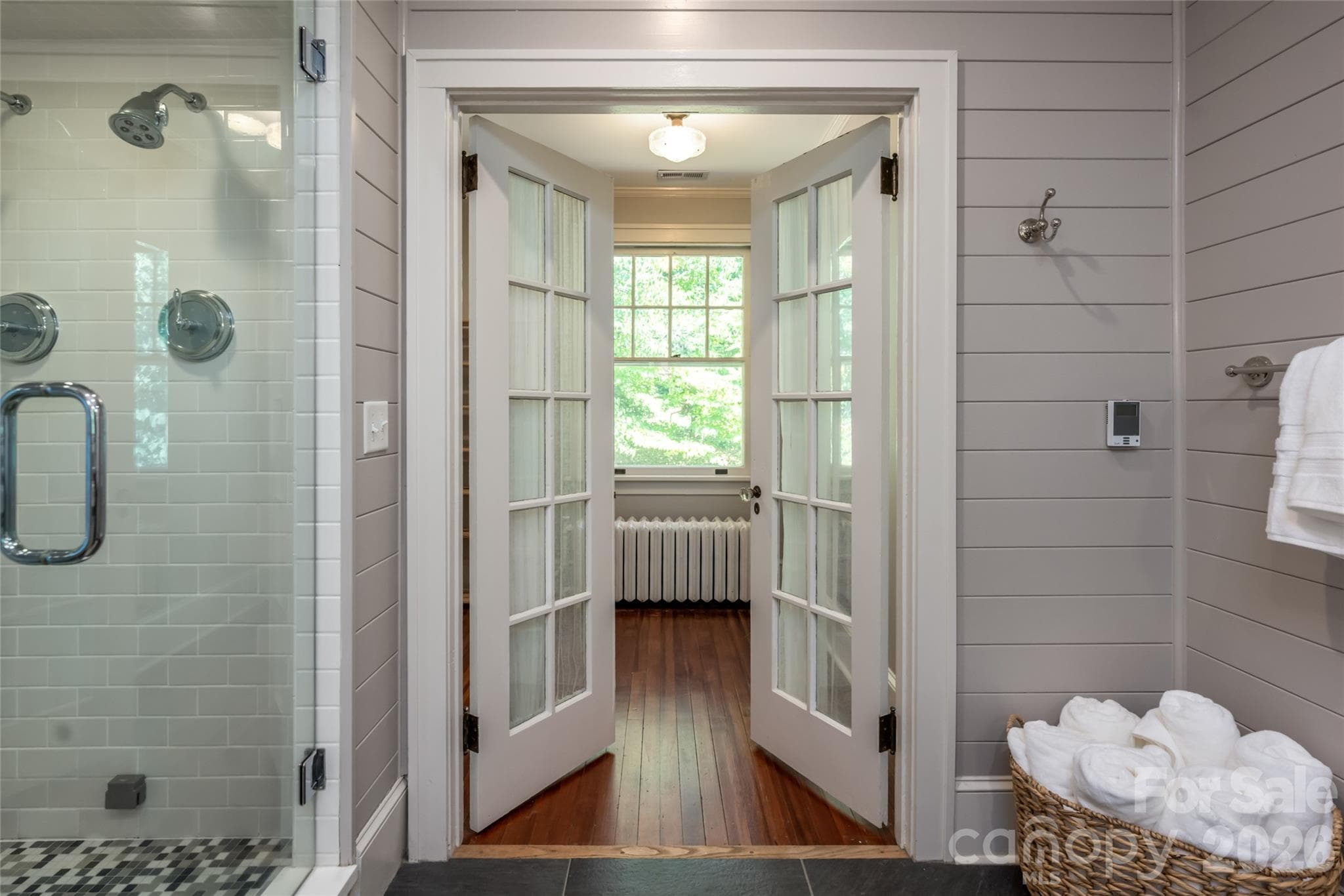 The primary bathroom features access into the larges second primary bedroom closet. - 35 Elias Place, Asheville
