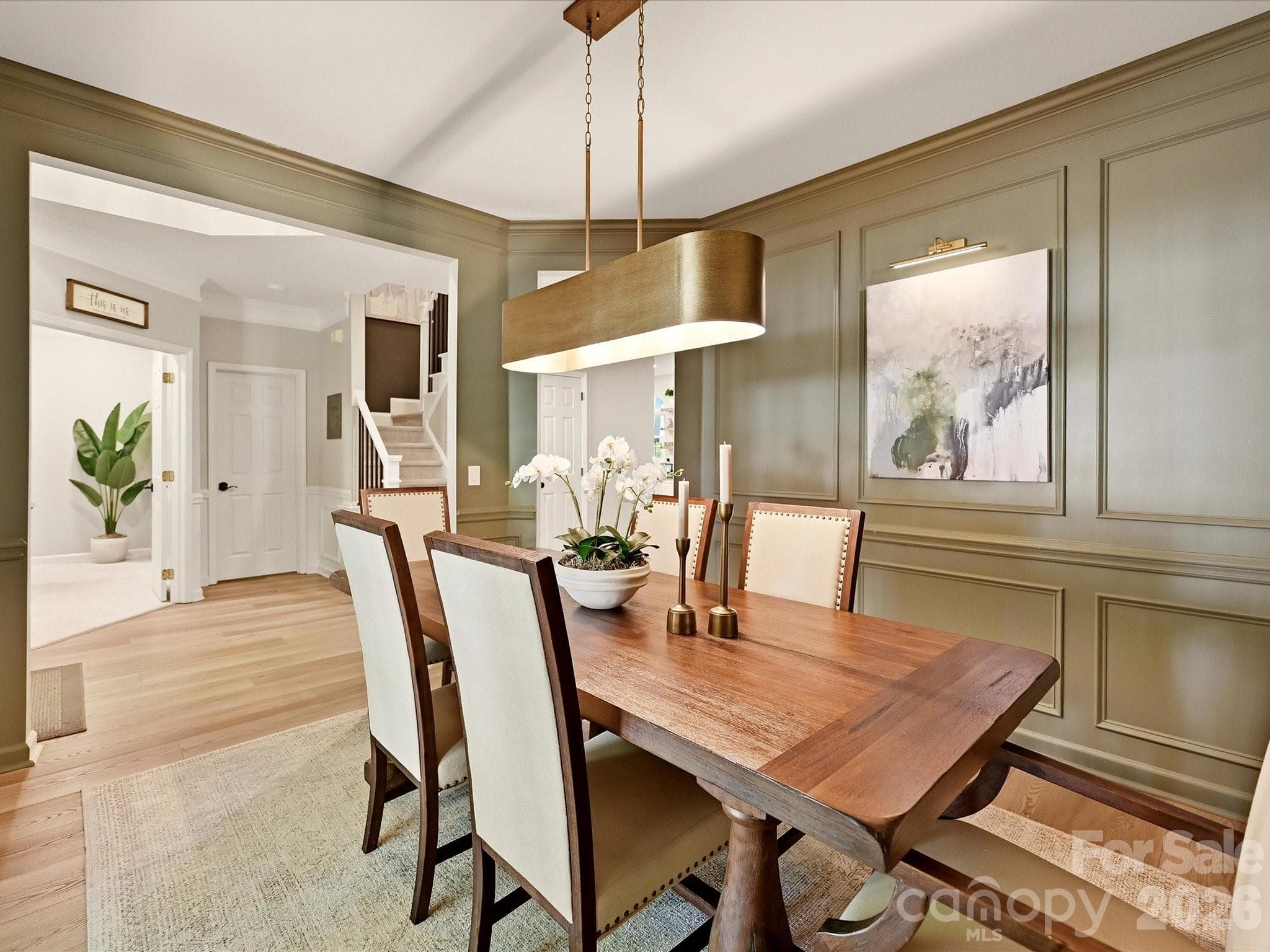 Additional dining room view highlights the beautiful millwork and easy connection to the kitchen and foyer. - 19706 Valiant Way, Cornelius