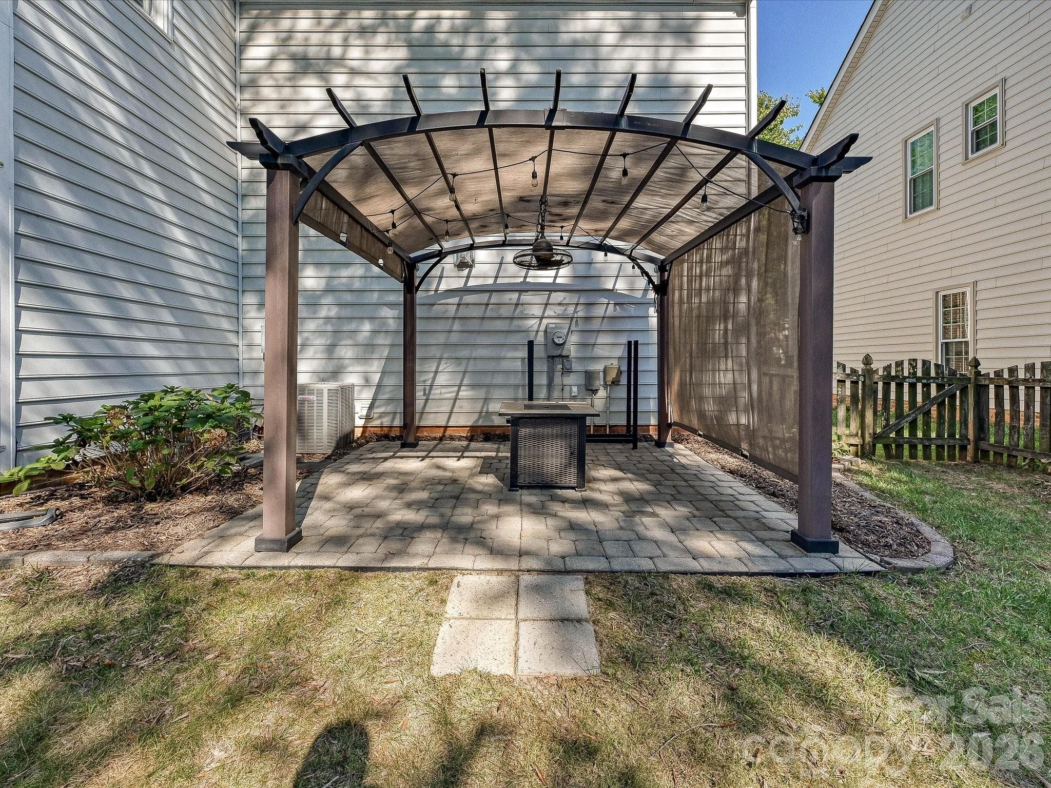 Backyard gazebo provides a shaded outdoor retreat within the private fenced yard. - 19706 Valiant Way, Cornelius