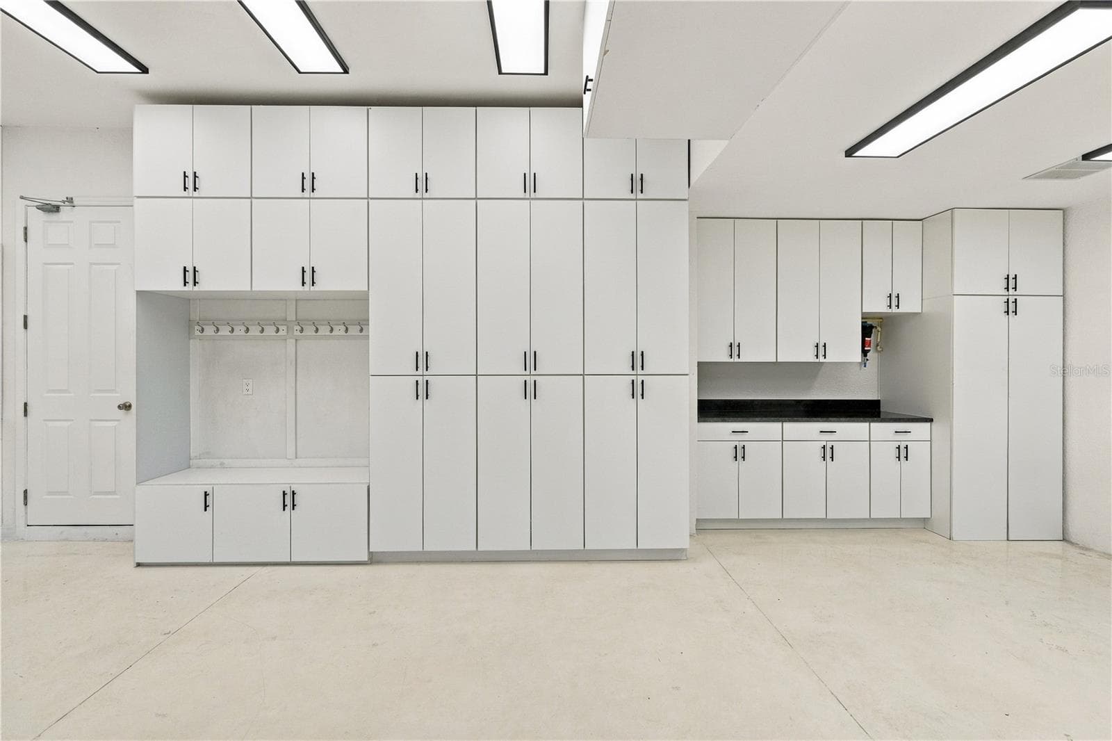 Garage with built-in cabinets - 27245 ROSELING CT, WESLEY CHAPEL