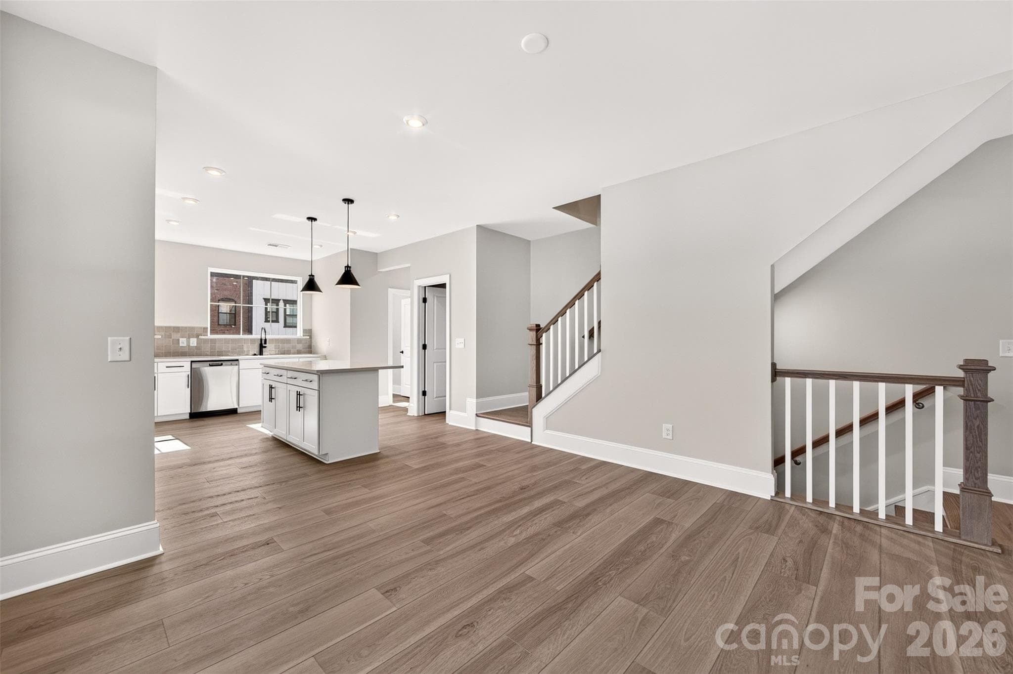 Light filled dining space with open rails on stairs - 411 Old Town Village Road, Waxhaw