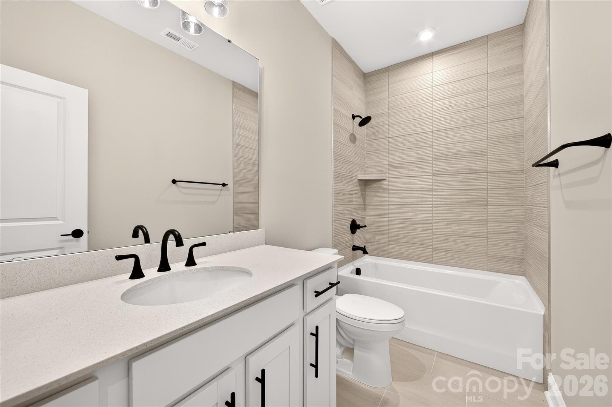 Secondary bathroom with tiled walls above the tub - 411 Old Town Village Road, Waxhaw