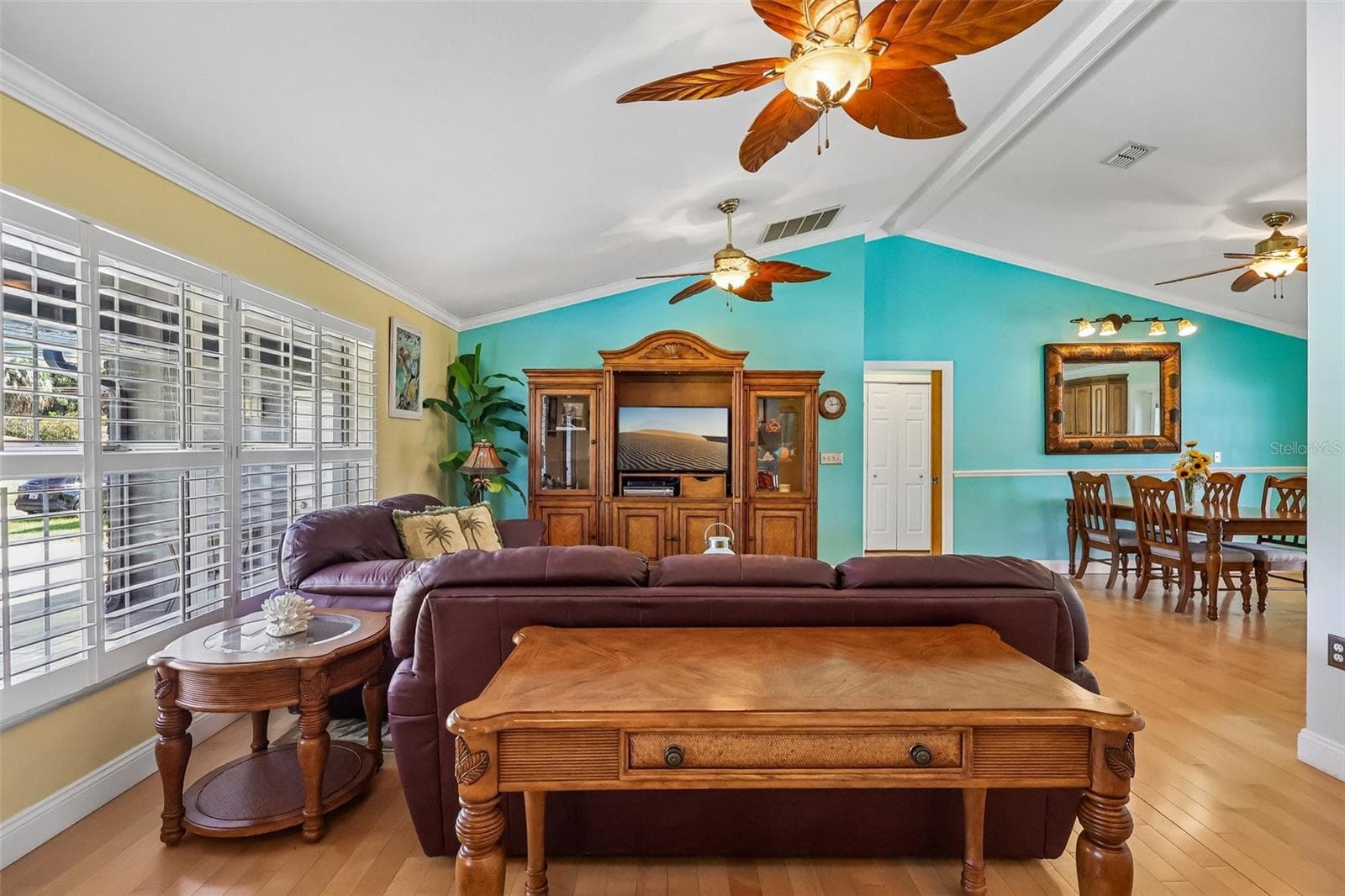 Living area with high ceilings and beautiful matching fans, and solid wood floors through out - 28116 LOIS DR, TAVARES