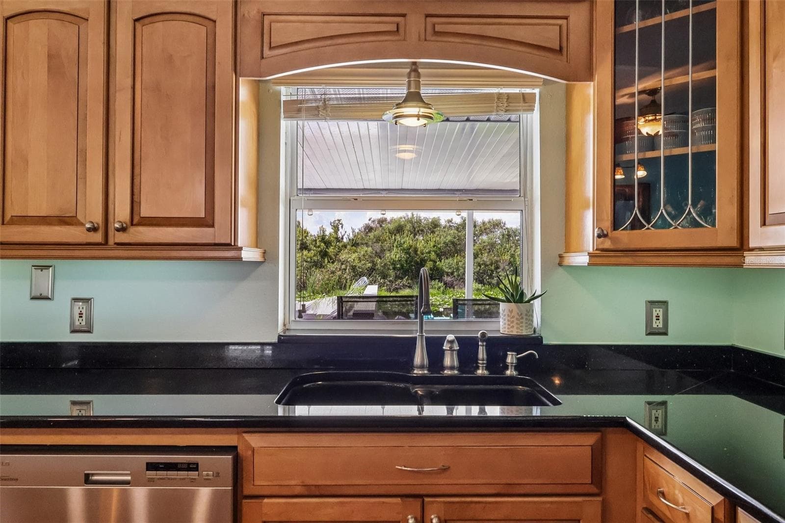 Kitchen window looking out to canal and decks - 28116 LOIS DR, TAVARES
