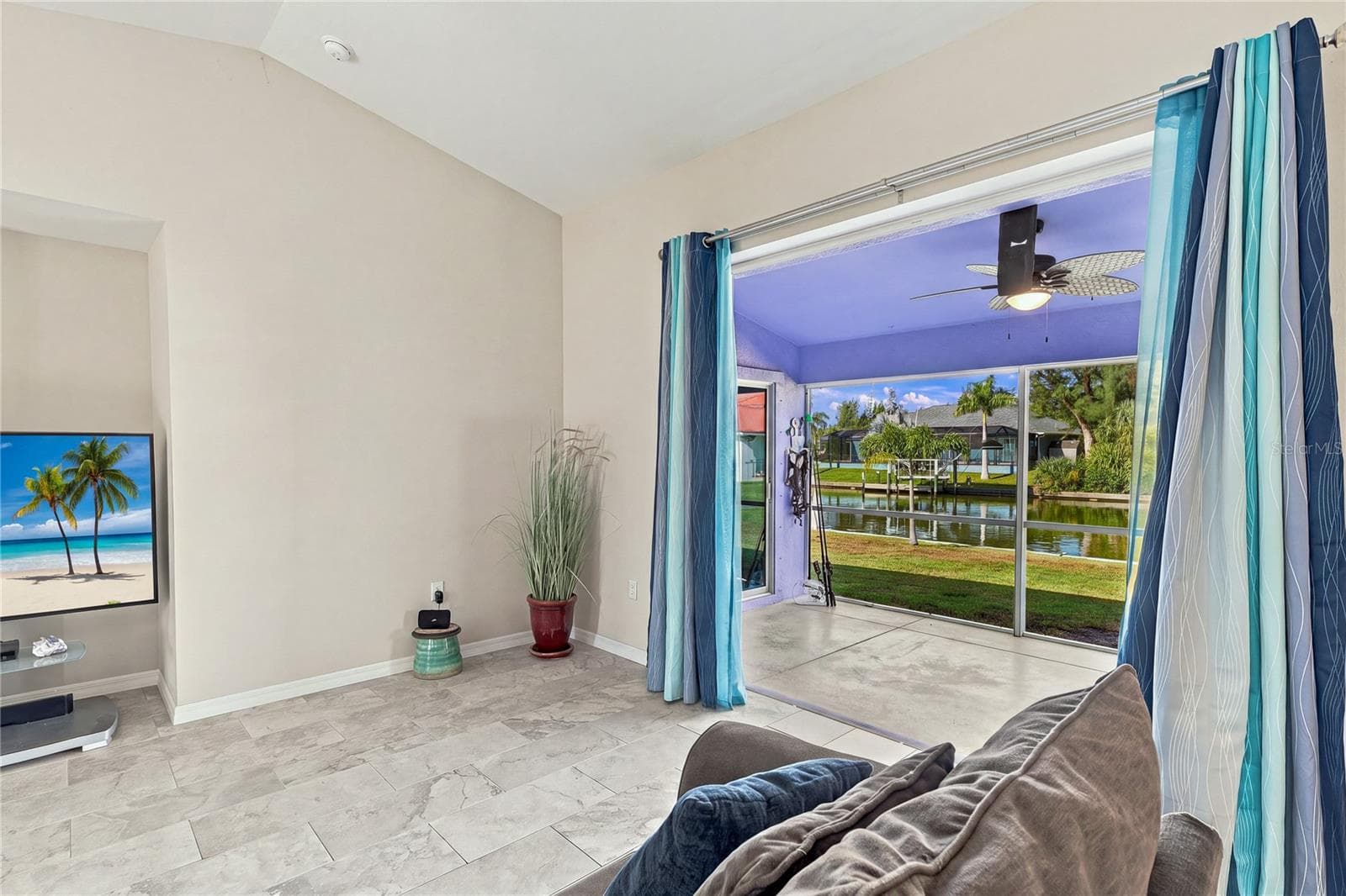 LIVING ROOM SLIDING DOOR POCKETS OPEN TO ALLOW YOU TO BRING THE OUTSIDE IN. GREAT FOR ENTERTAINING - 10554 LIVE OAK RD, PORT CHARLOTTE